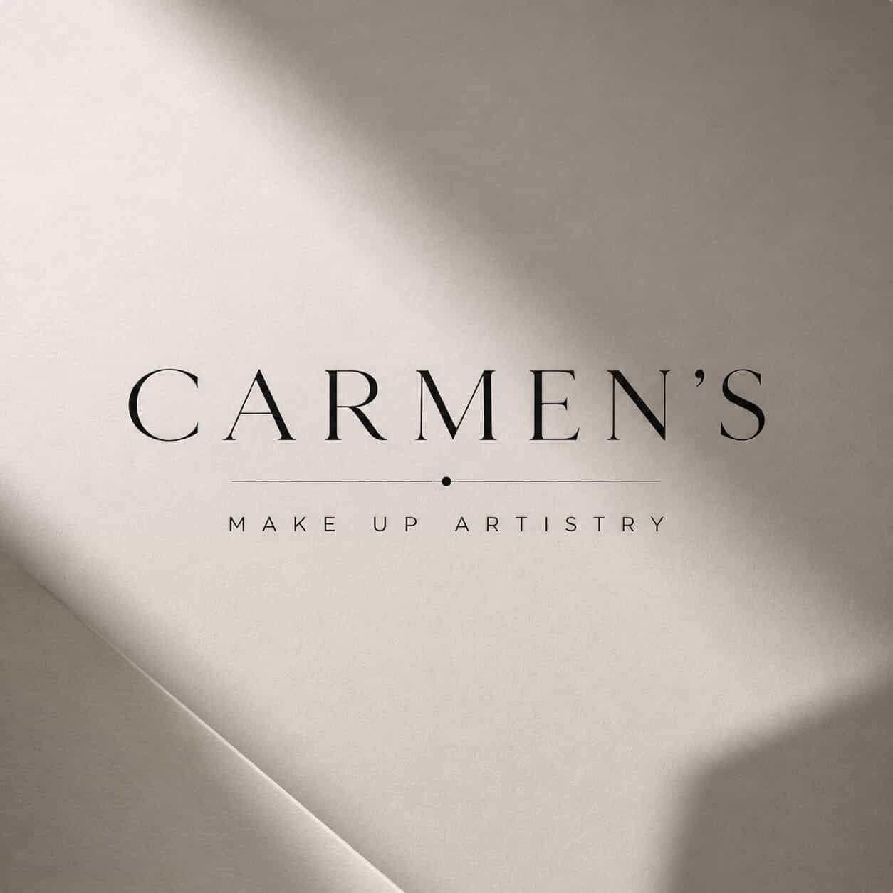 Carmen's Make Up Artistry logo on a neutral beige background with soft shadow lighting.
