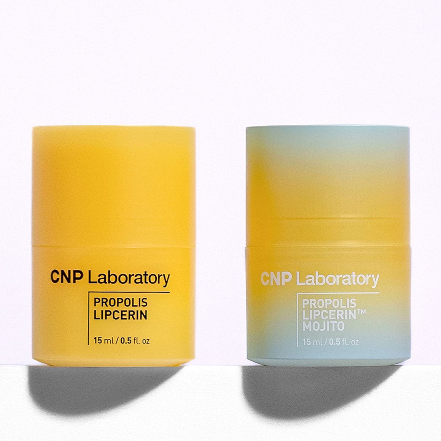 Two yellow skincare containers from CNP Laboratory featuring Propolis Lipicerin products cast shadows against a white surface.