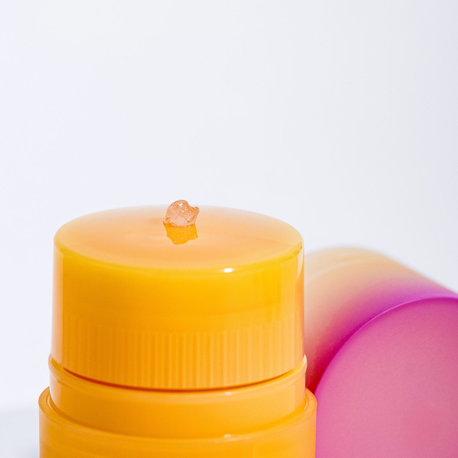 Colorful skincare containers in yellow and pink with CNP Laboratory branding on a white background.