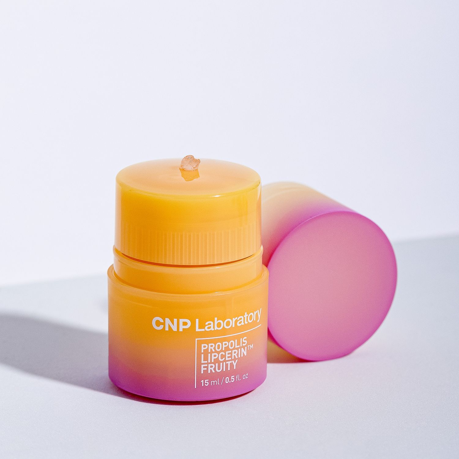 Colorful skincare containers in yellow and pink with CNP Laboratory branding on a white background.