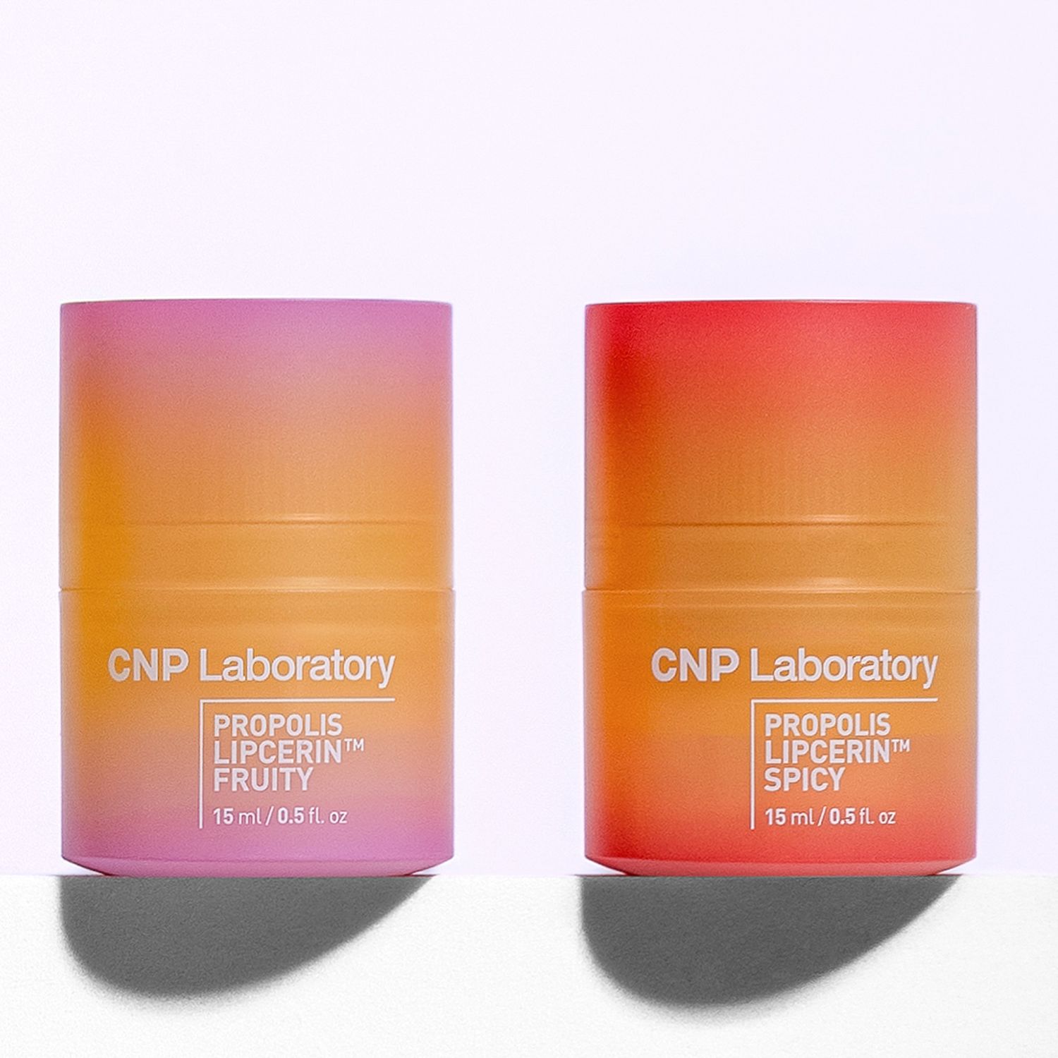 Pink and orange gradient skincare bottles from CNP Laboratory's Propolis Lipocerin collection on white surface.