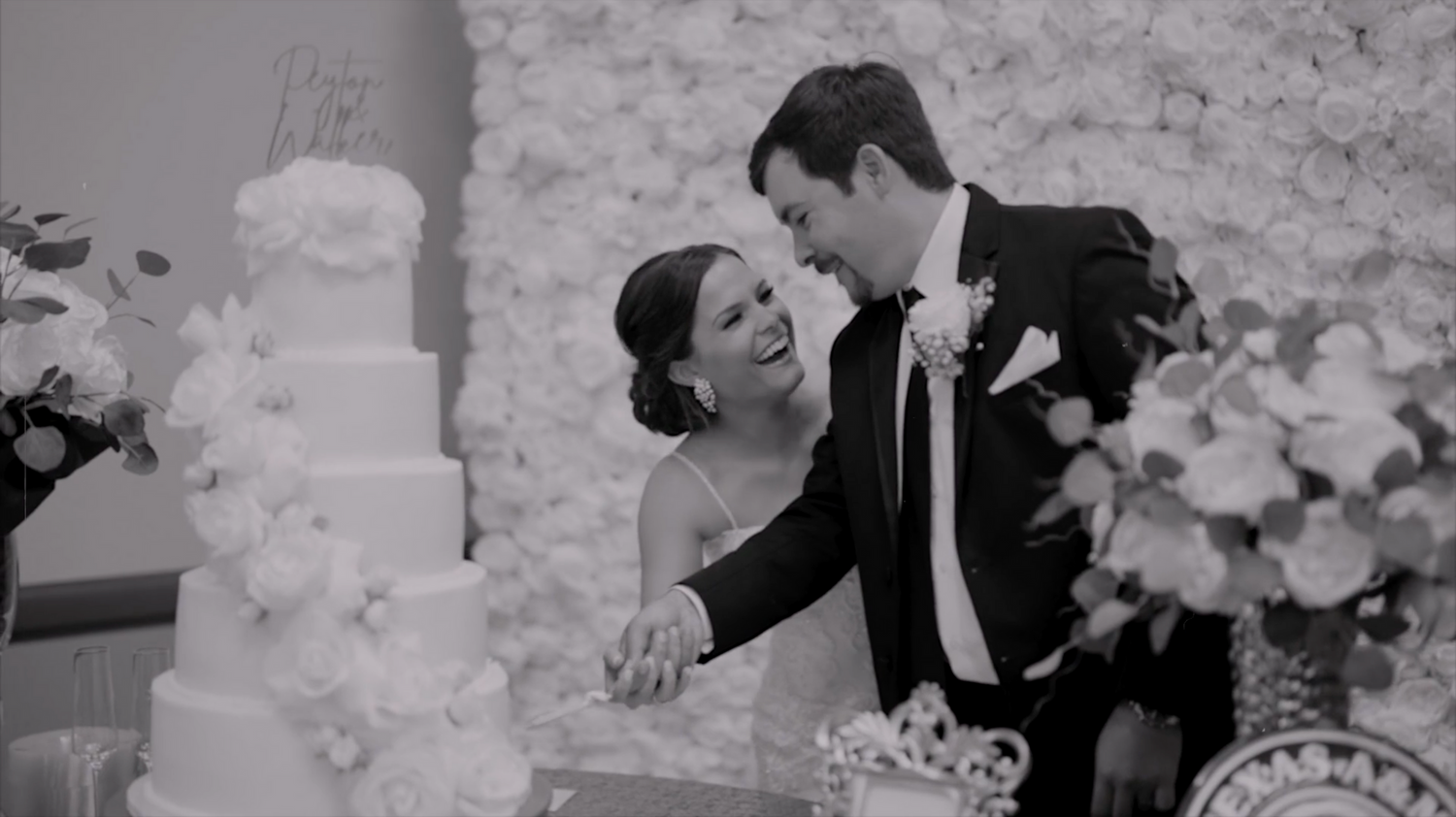 A series of black and white wedding photos showing joyful moments at the ceremony and reception.