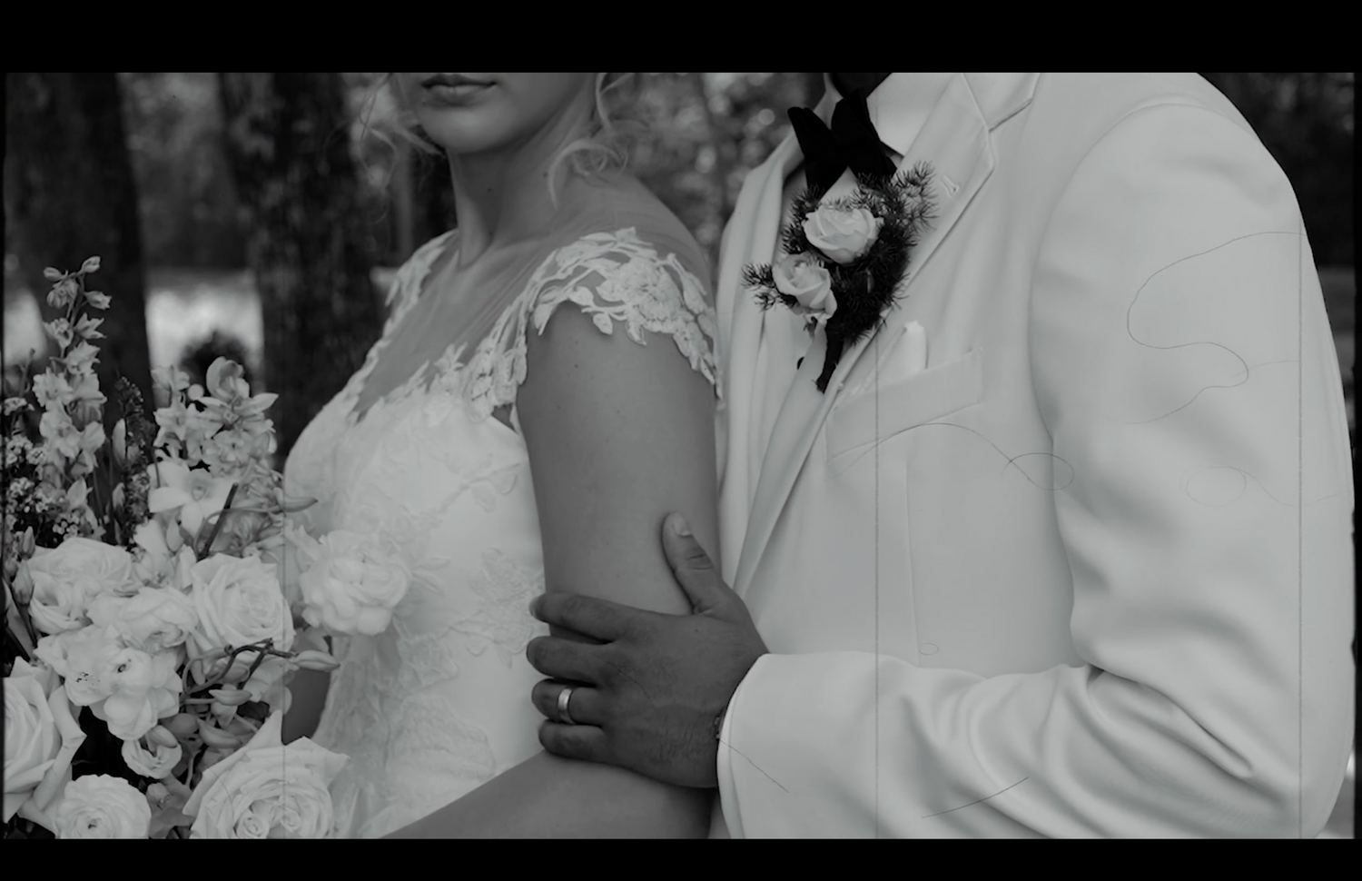 A tender moment between newlyweds captured in an artistic black and white photograph.