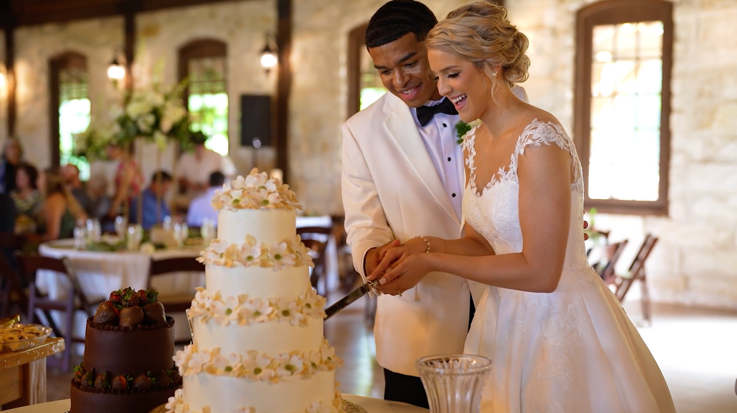 Wedding reception sequence showing cake cutting and celebration moments in warm lighting.