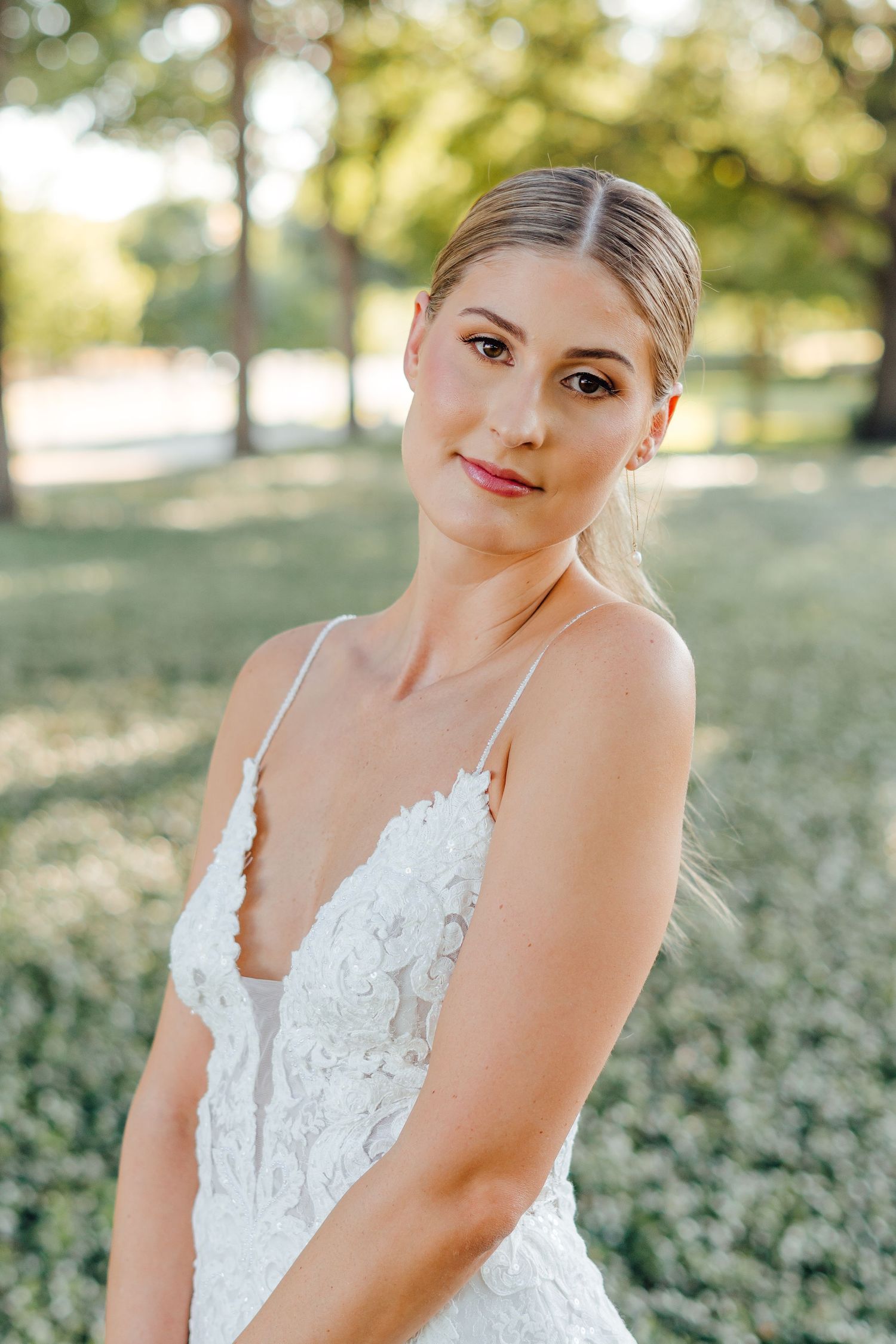 Romantic outdoor bridal portrait featuring delicate lace details and soft natural lighting.