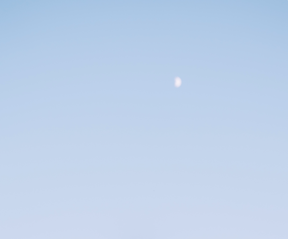 Empty light blue sky background with soft gradient.