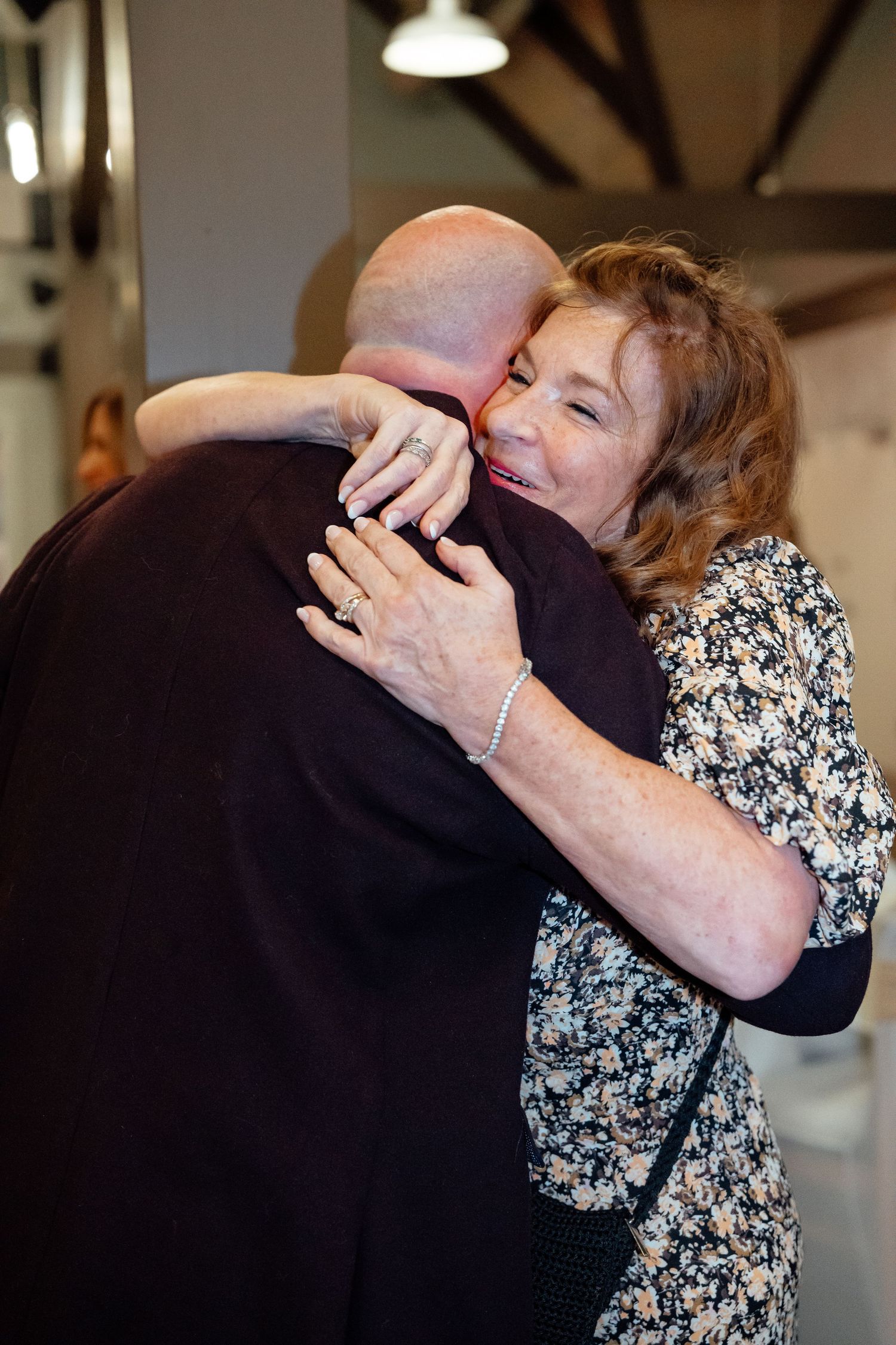 Two people sharing an emotional embrace during a special celebration event.