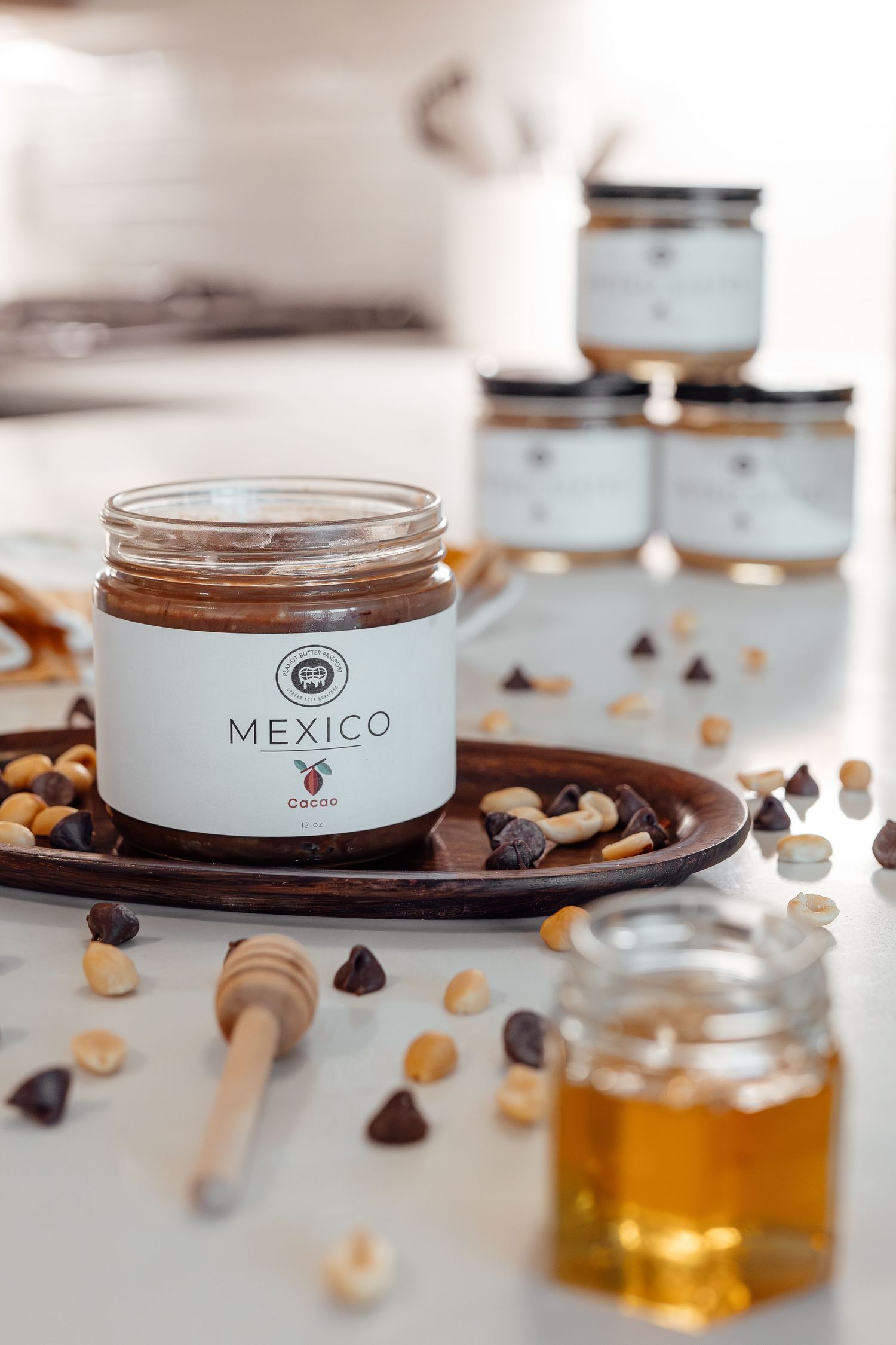 Chocolate jars and ingredients arranged on a white surface with honey.