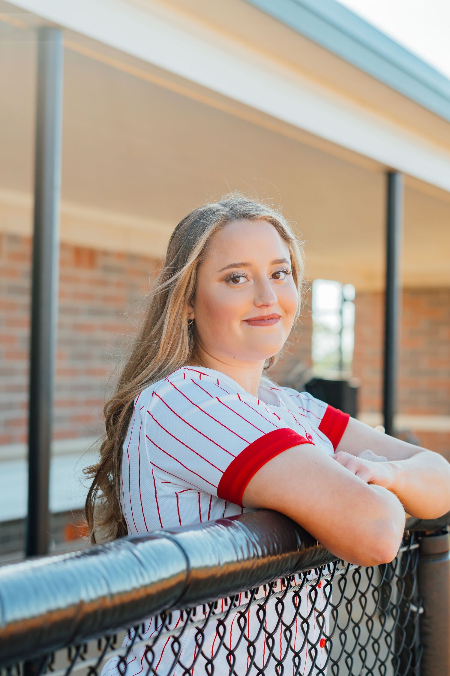 Baseball themed portrait series leaning against dugout fence.