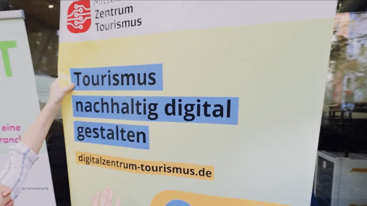 A blurred view of German text signs and banners with 'Tourismus' and other words visible through glass.