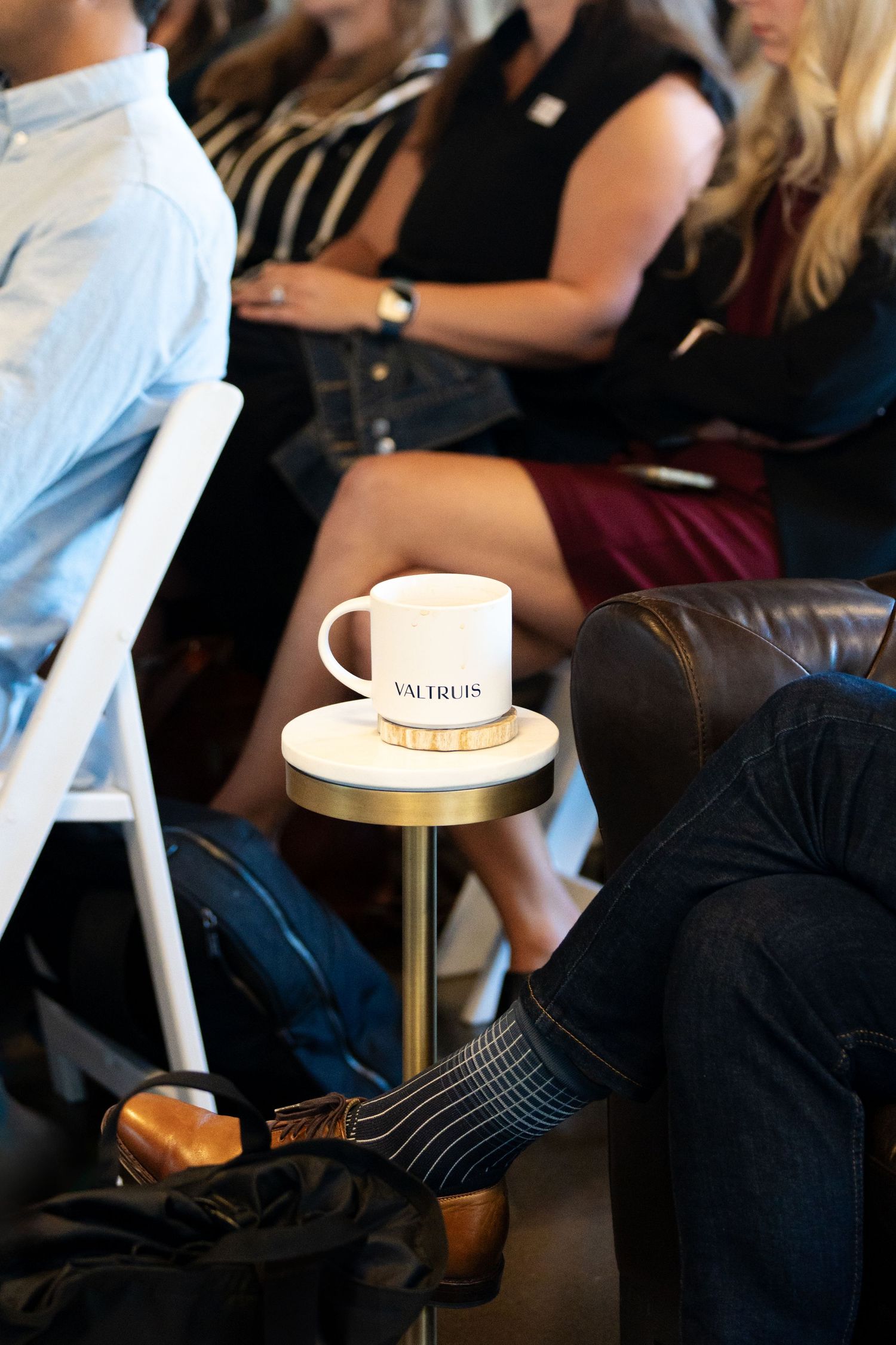 A series of cropped images showing people sitting on dark leather furniture in a casual indoor setting.