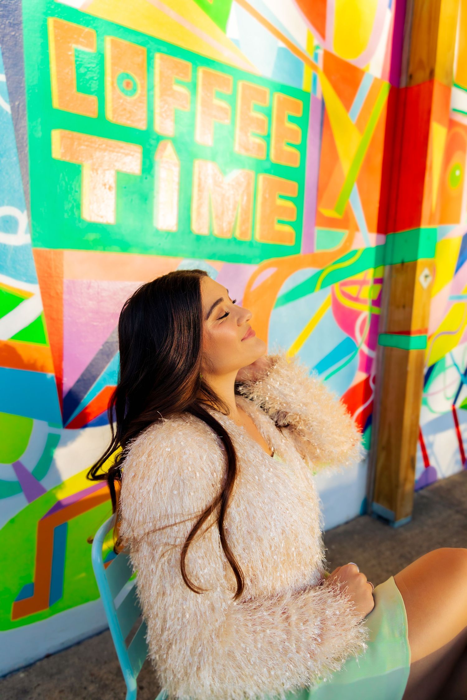 Nashville portrait session at the old landing dock. Colorful geometric mural with bright patterns in green, yellow and pink.