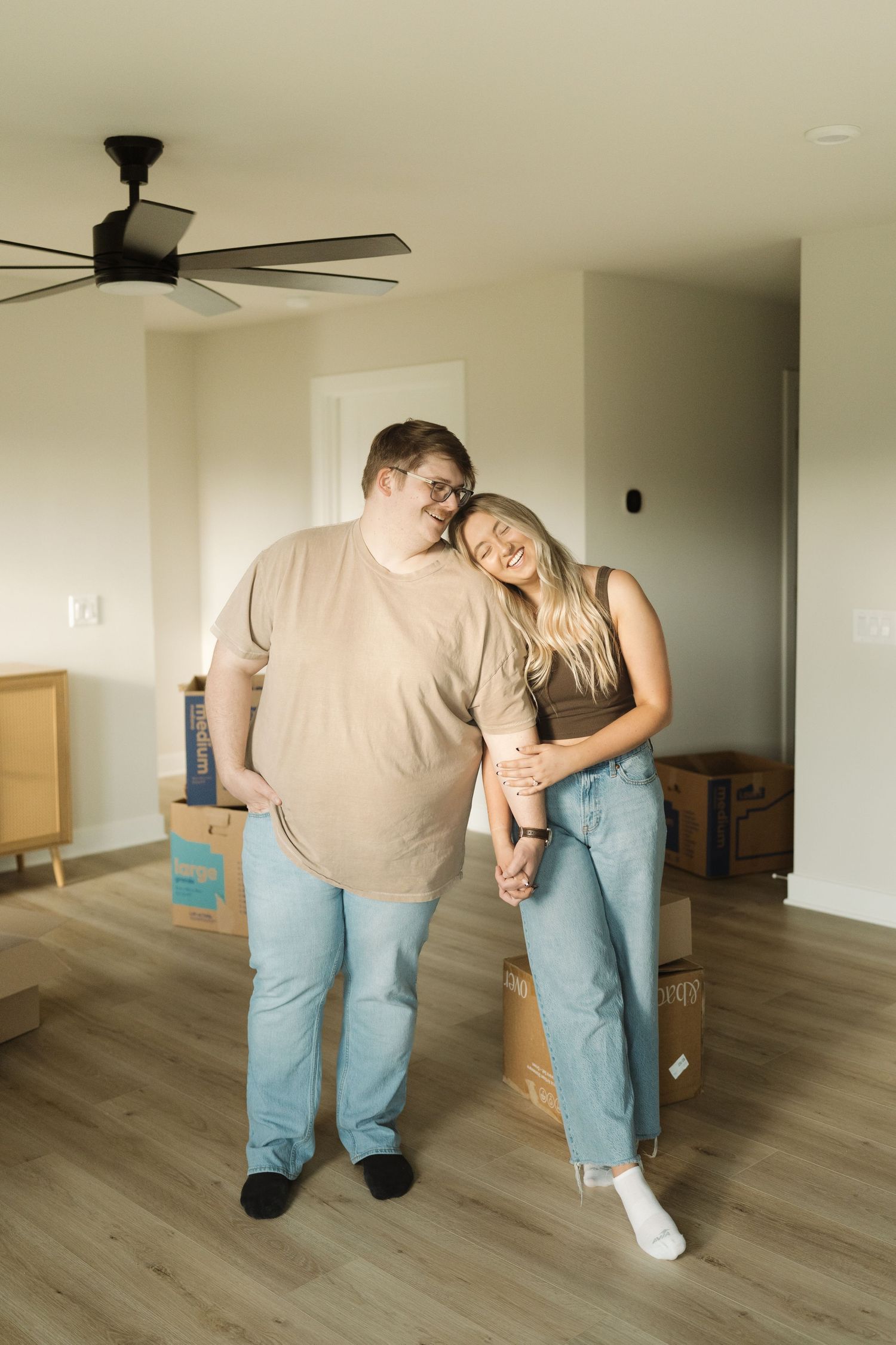 A sequence of photos showing two people performing a dance dip move on a hardwood floor in an empty room.