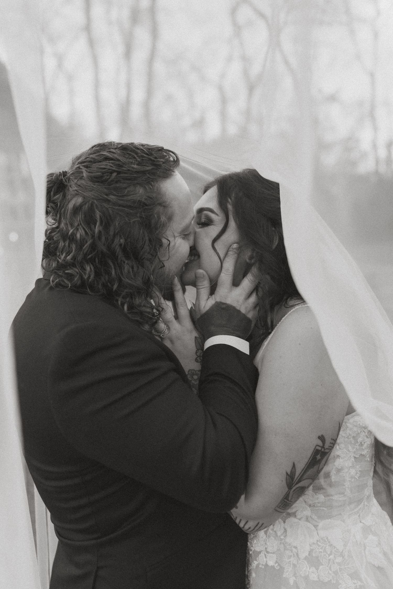 Intimate black and white wedding portrait capturing romantic moment through veil in nashville tennessee.