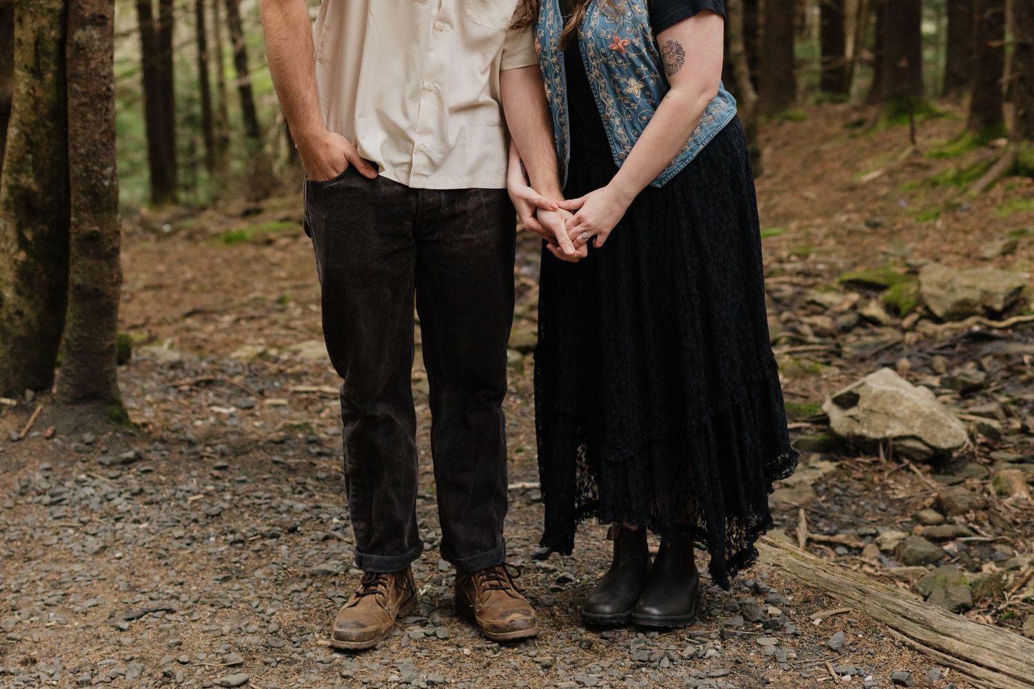 Family group photo session in casual attire against forest backdrop.