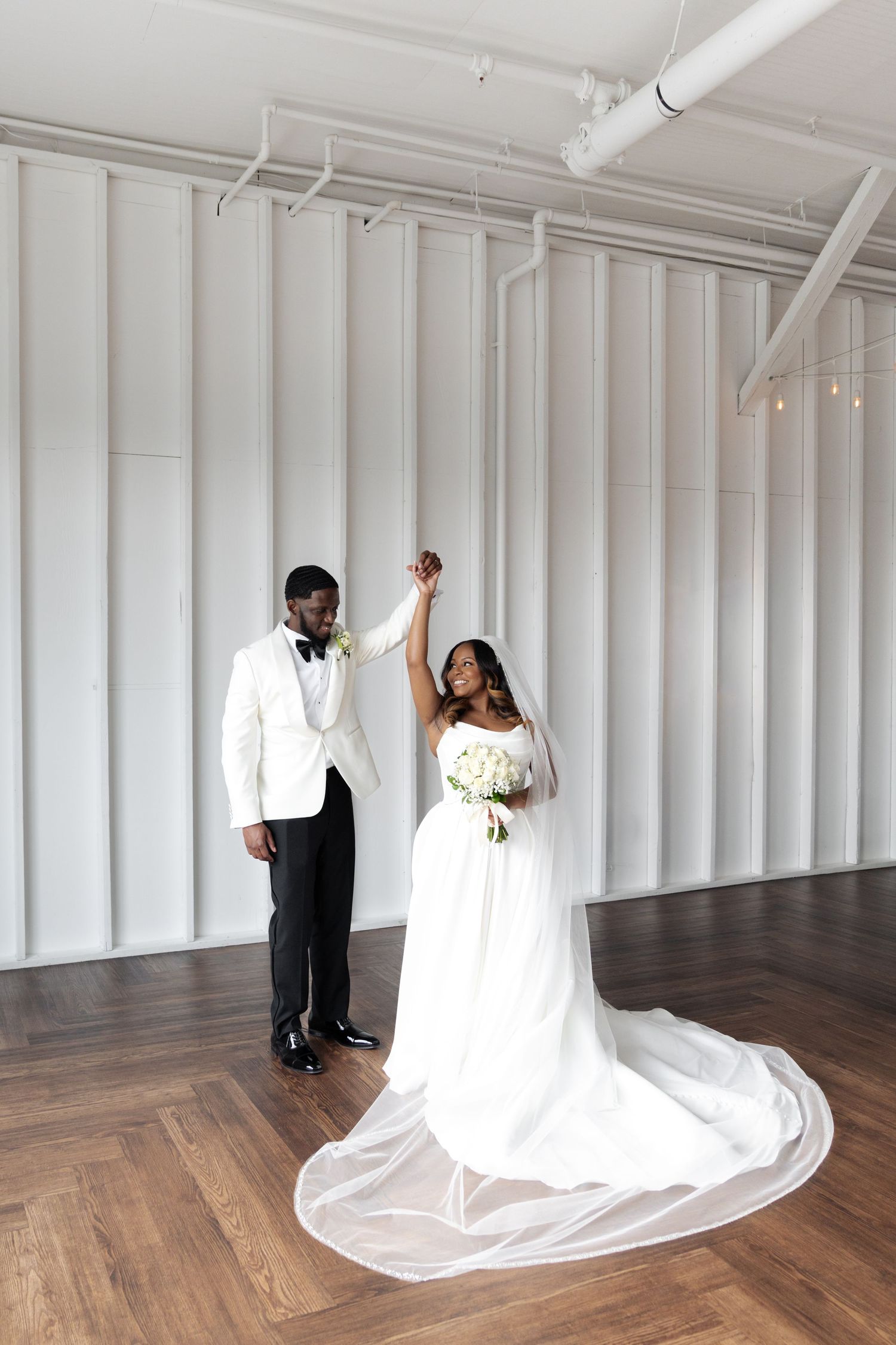 Wedding couple poses in artistic sequence against white industrial indoor wedding backdrop at 14 twelve venue in nashville tennessee.