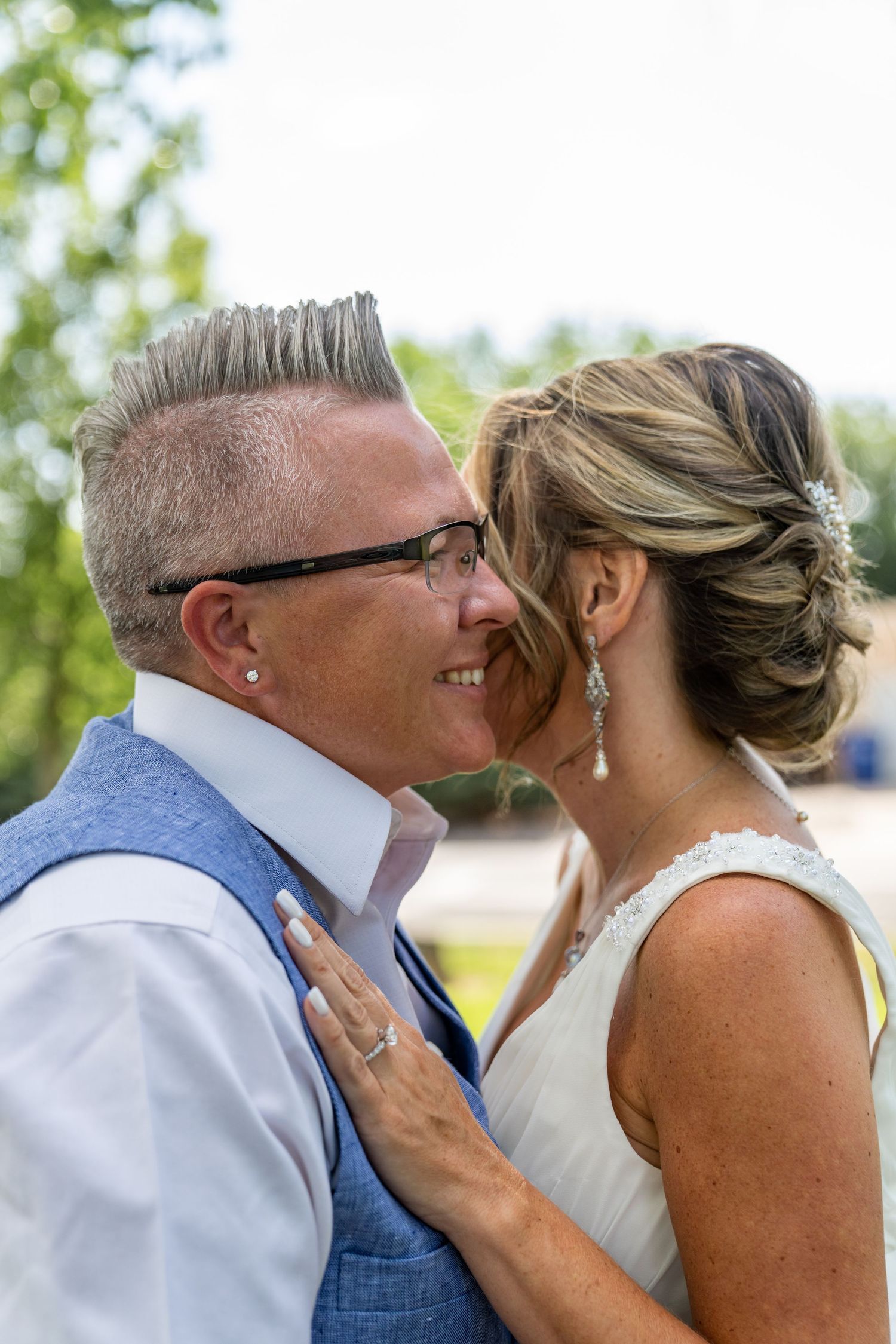 A romantic sequence of wedding photos showing a tender kiss between a couple in outdoor setting.