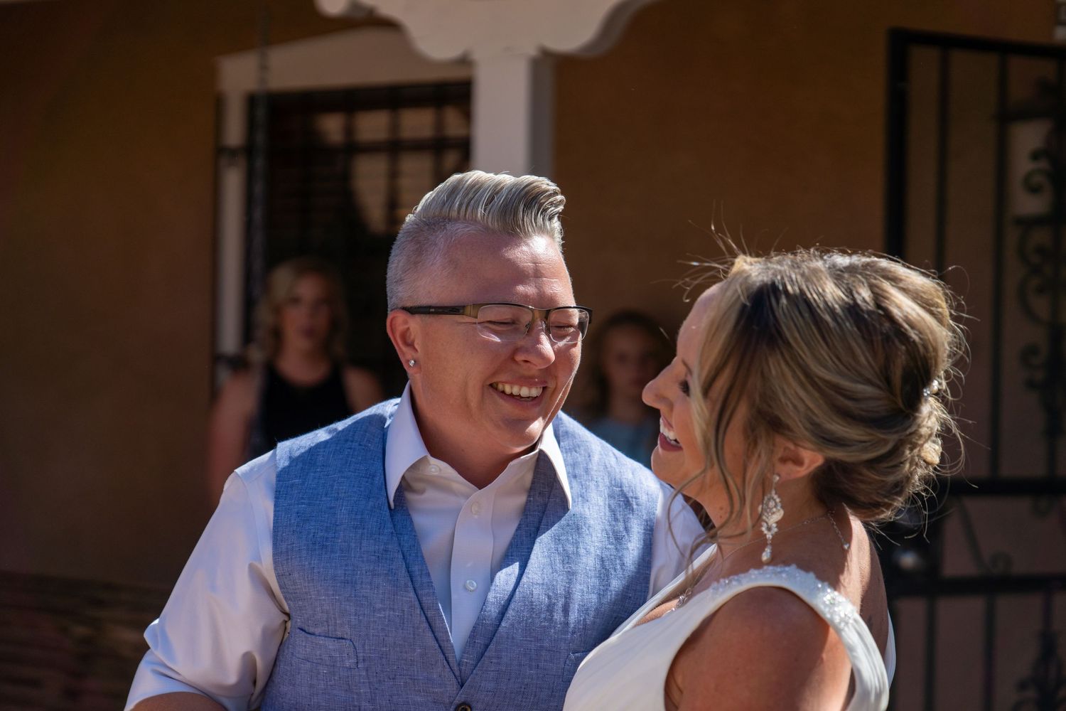 A couple shares an intimate moment during a wedding ceremony in a traditional church setting.