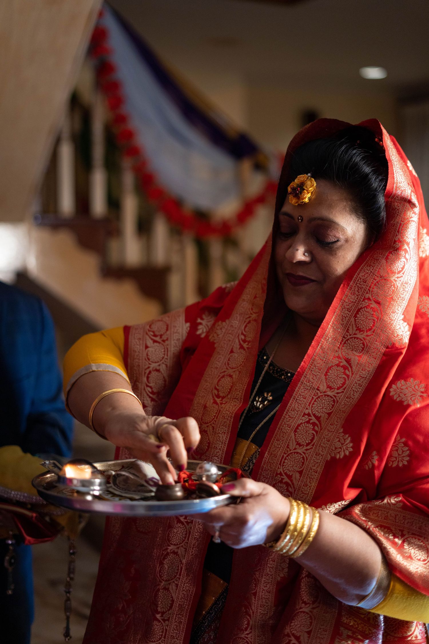 A sequence showing hands in traditional Indian attire preparing and serving food during a cultural celebration.