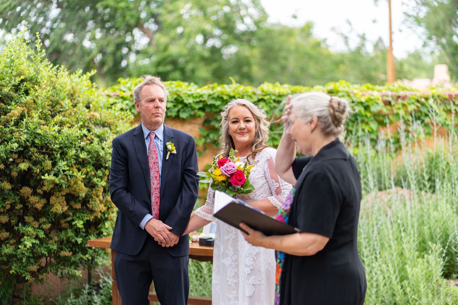Wedding ceremony moments captured in a beautiful garden setting with natural landscaping.