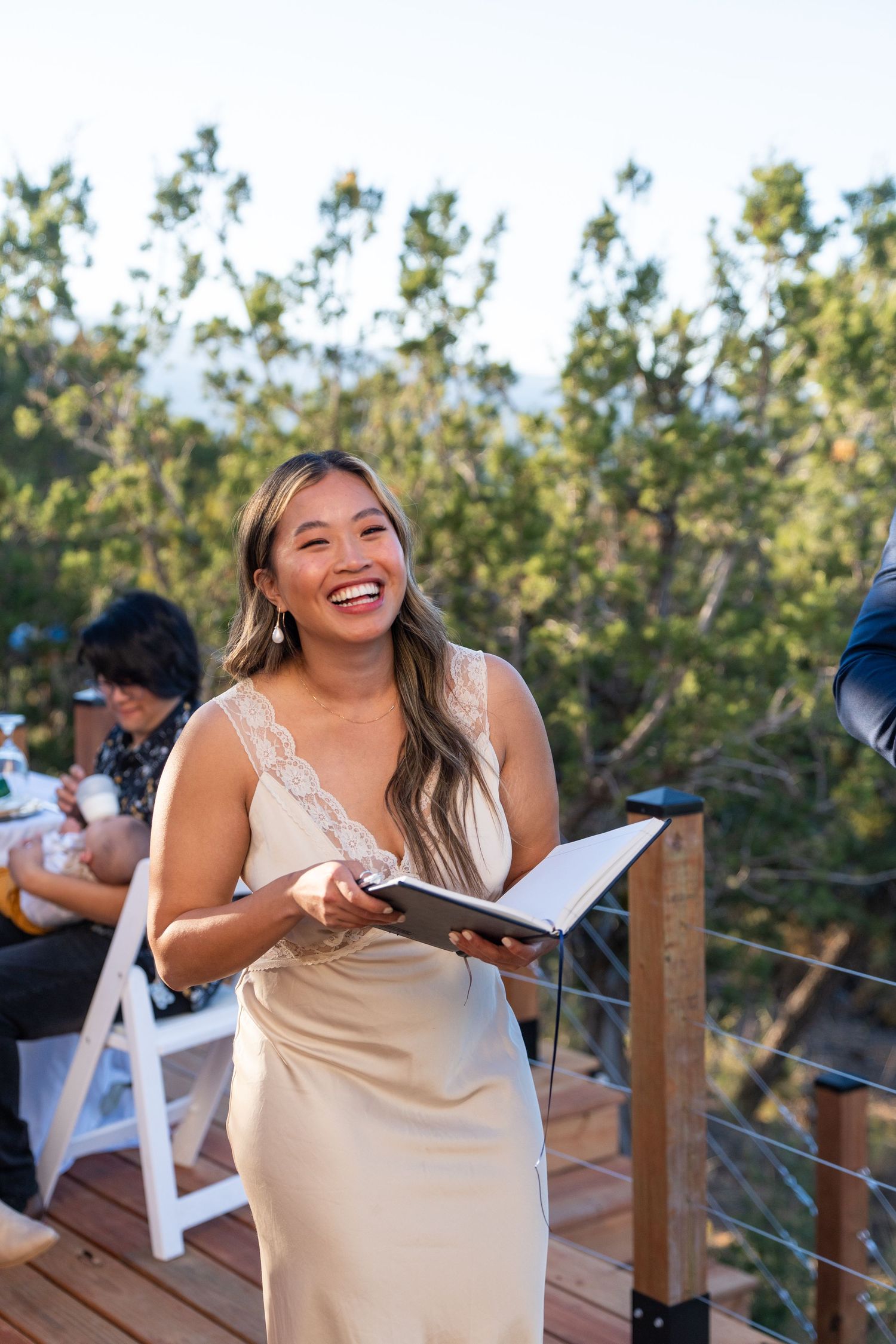 Joyful celebration moment on an outdoor wooden deck during a special event.