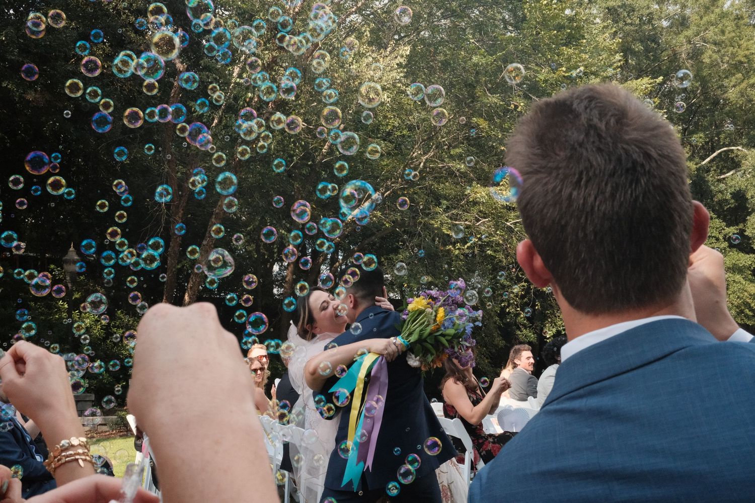 Festive outdoor celebration with floating bubbles creating a magical atmosphere.