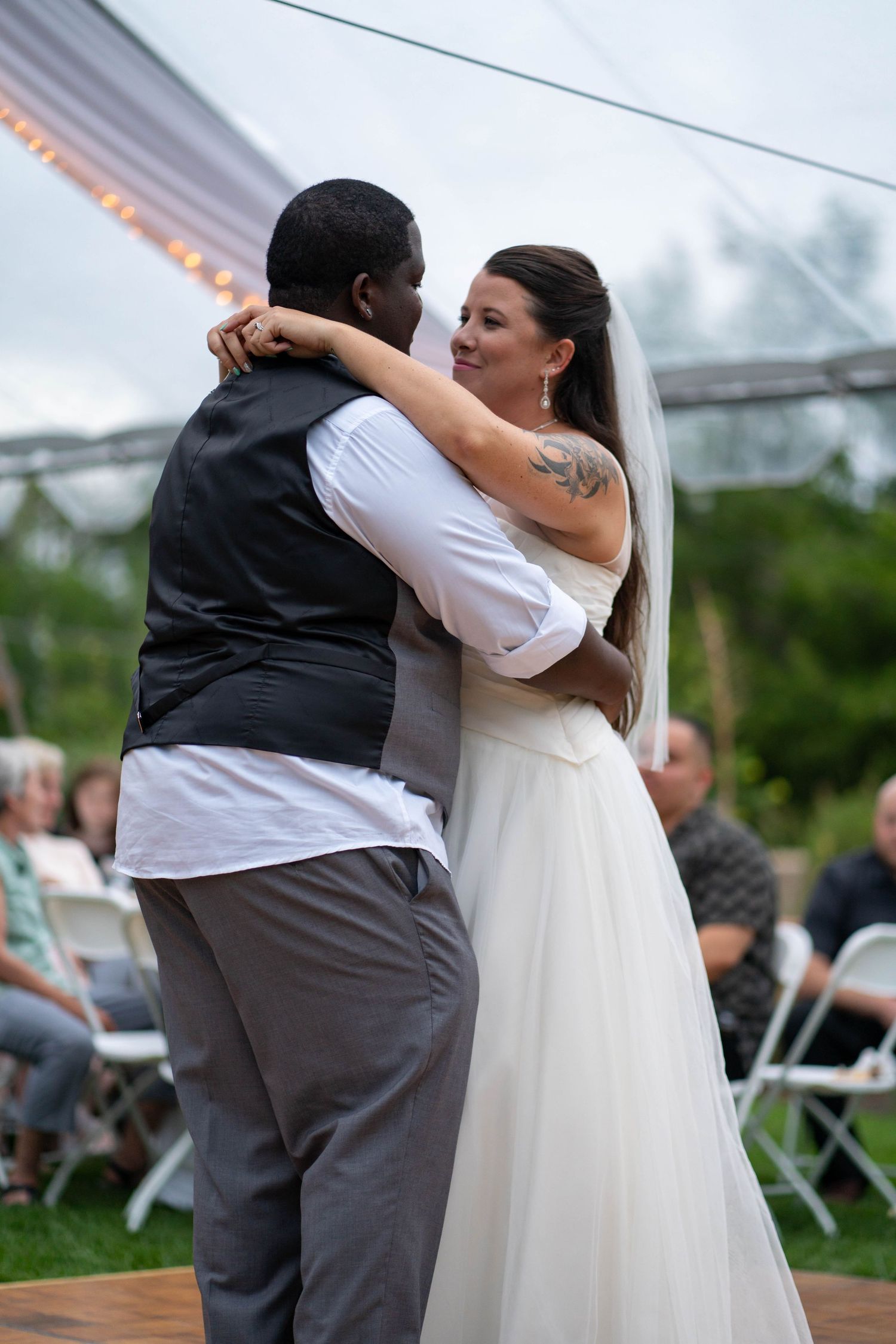 A series of wedding dance photos showing joyful movement and twirling on an outdoor dance floor.