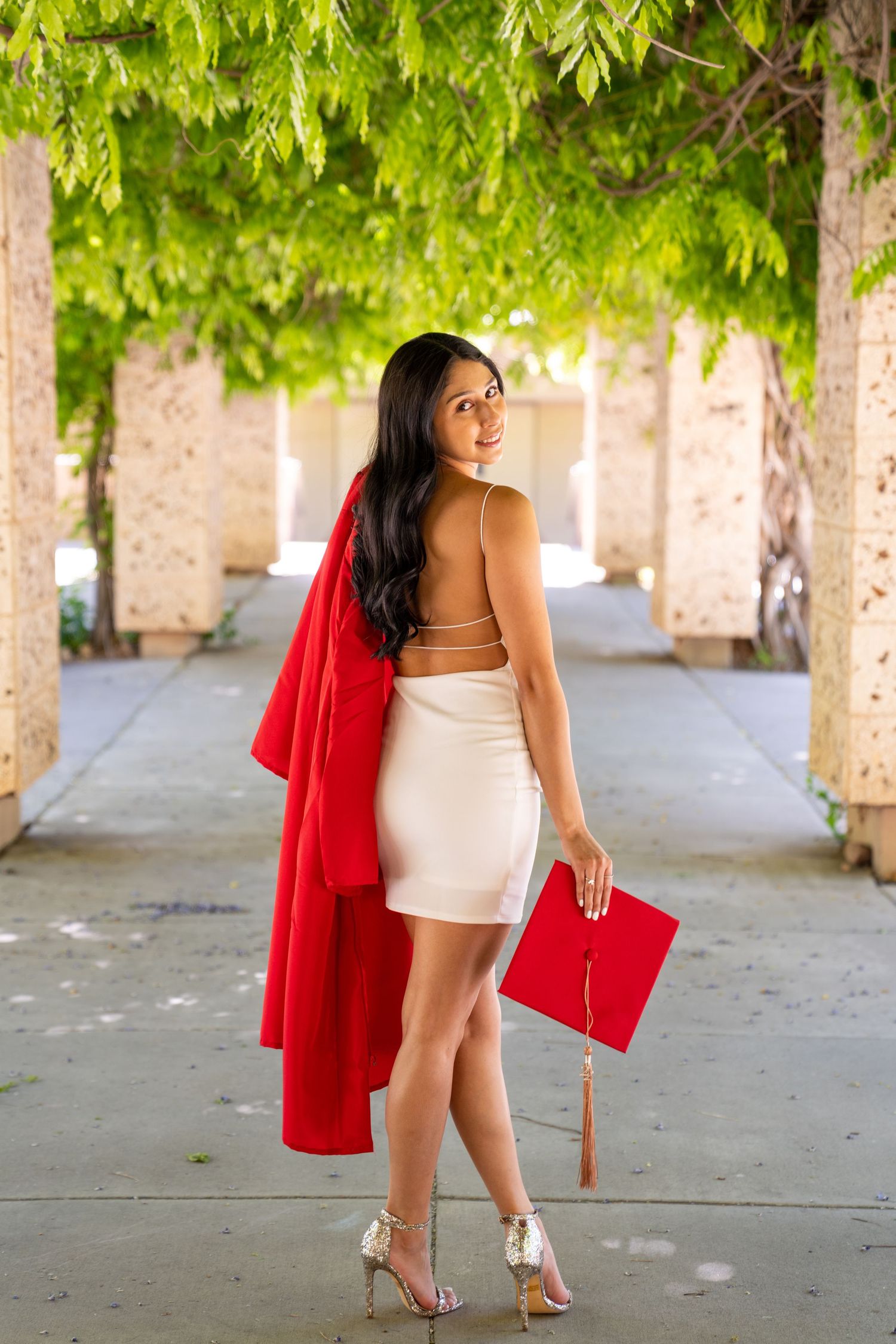 A series of fashion photos showing a white crop top and red blazer outfit in an outdoor colonnade setting.