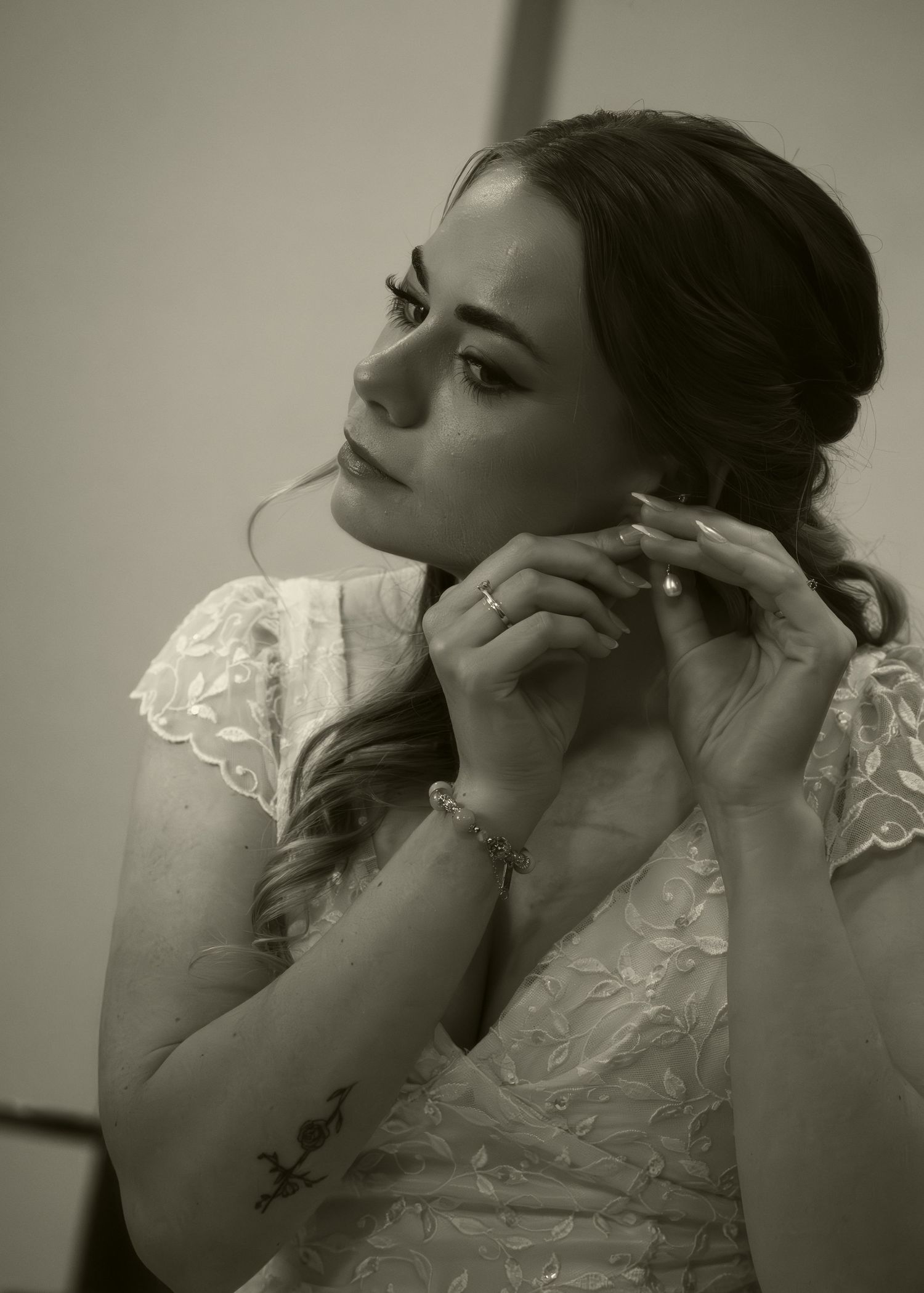 A series of artistic black and white portraits showing someone in delicate lace against a neutral background.