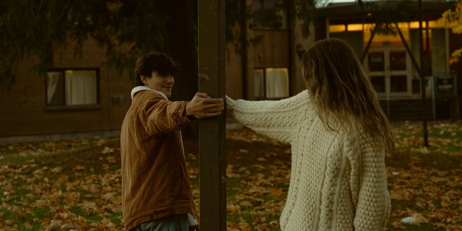 Motion blur of people walking through an autumn park at dusk.