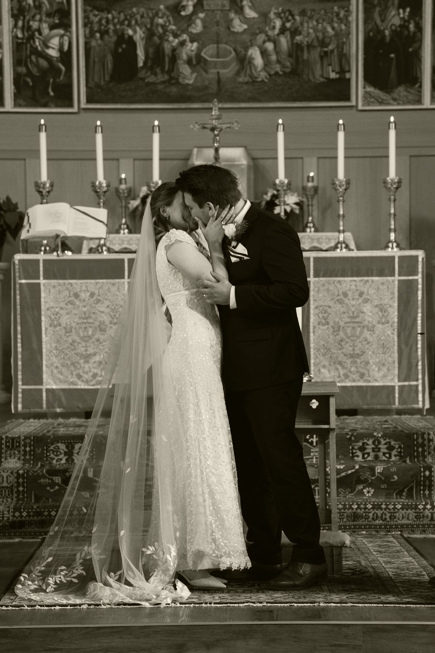 Wedding ceremony setup in a church with white candles and elegant decor along the aisle.