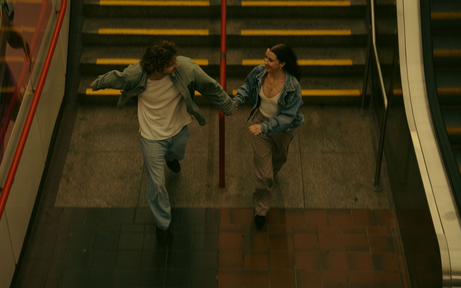 Couple running away in love, below to city streets