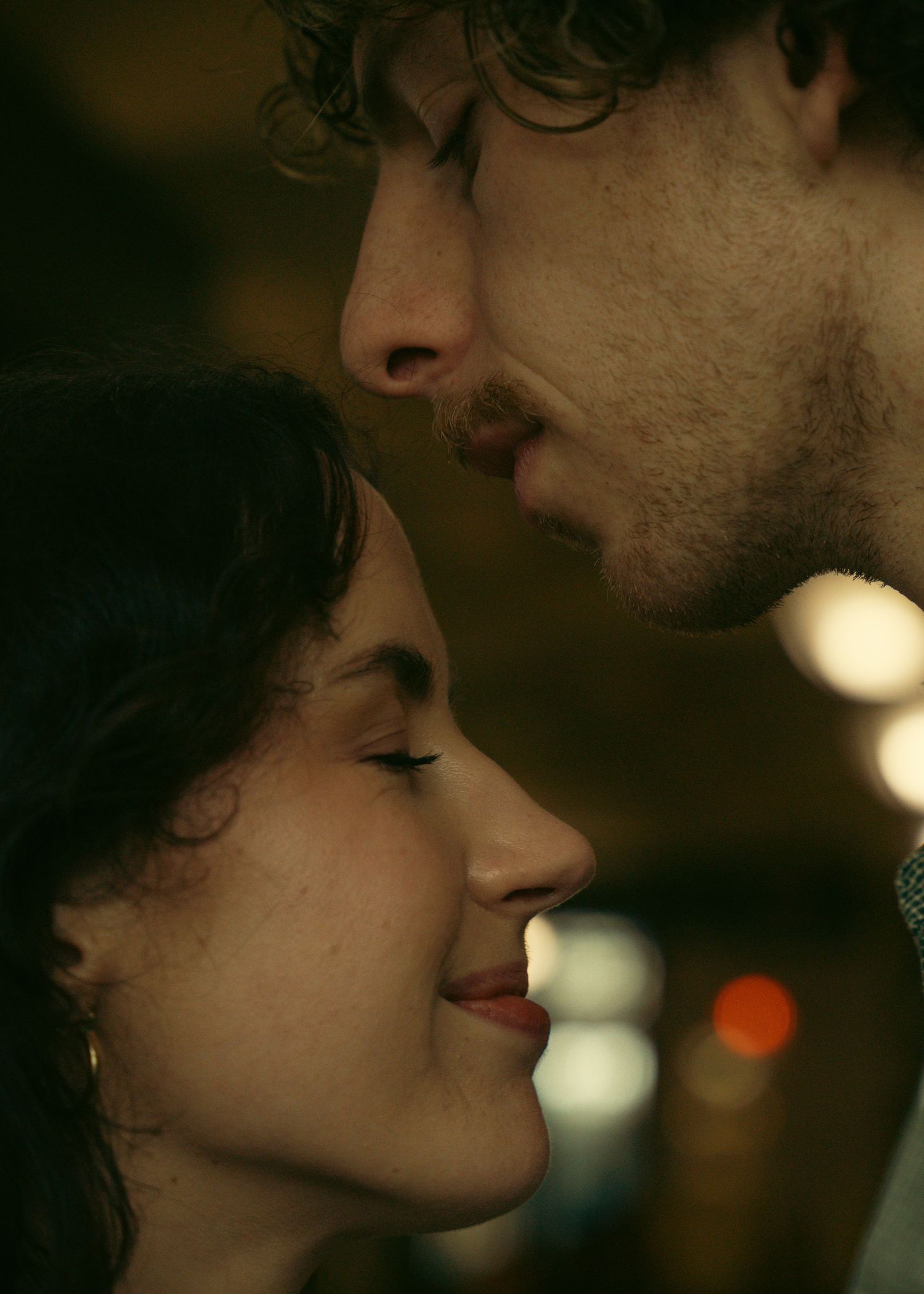 Intimate close-up shot in warm lighting with soft focus.