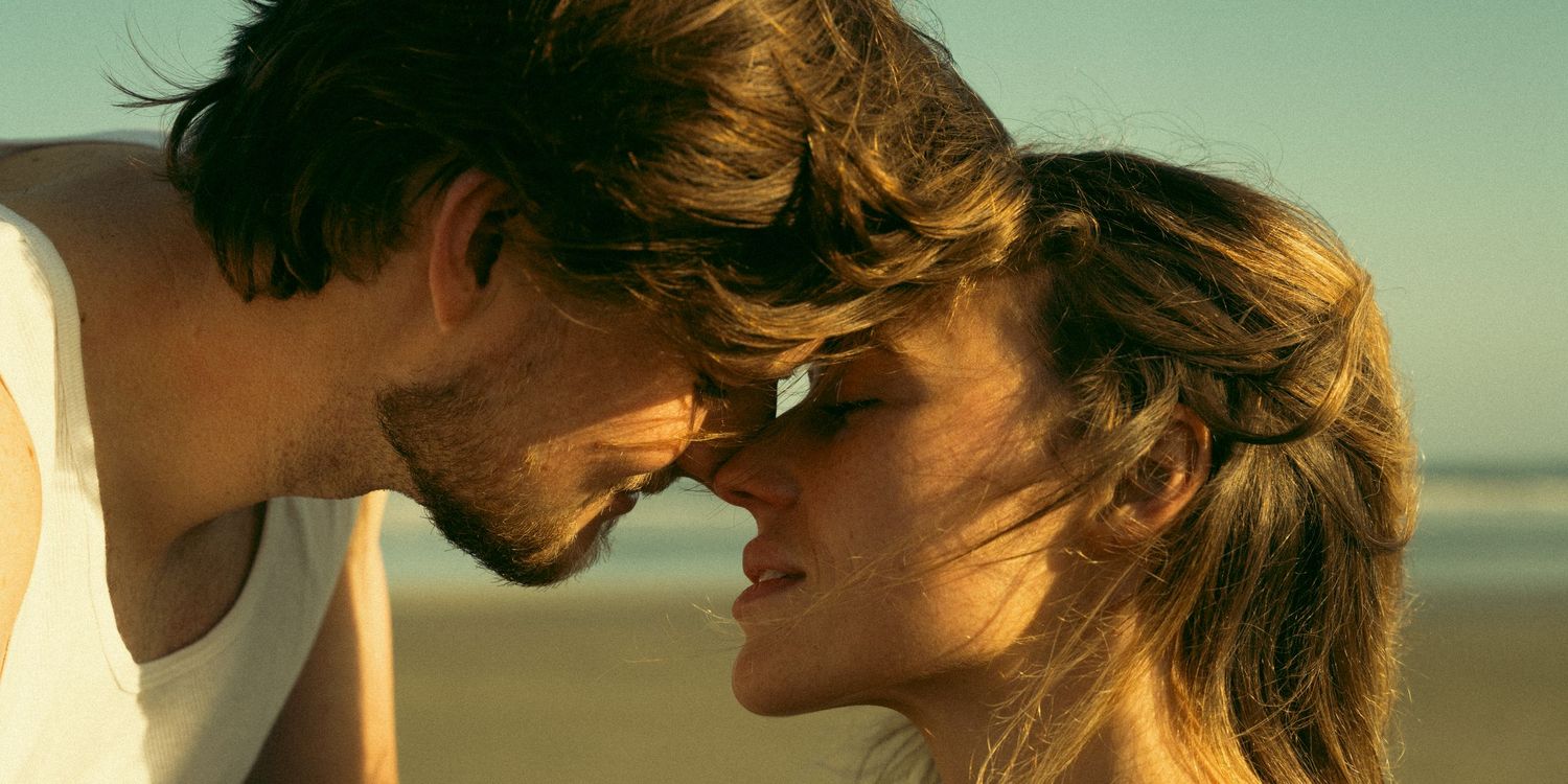 A romantic couple sharing an intimate moment at sunset on the beach.