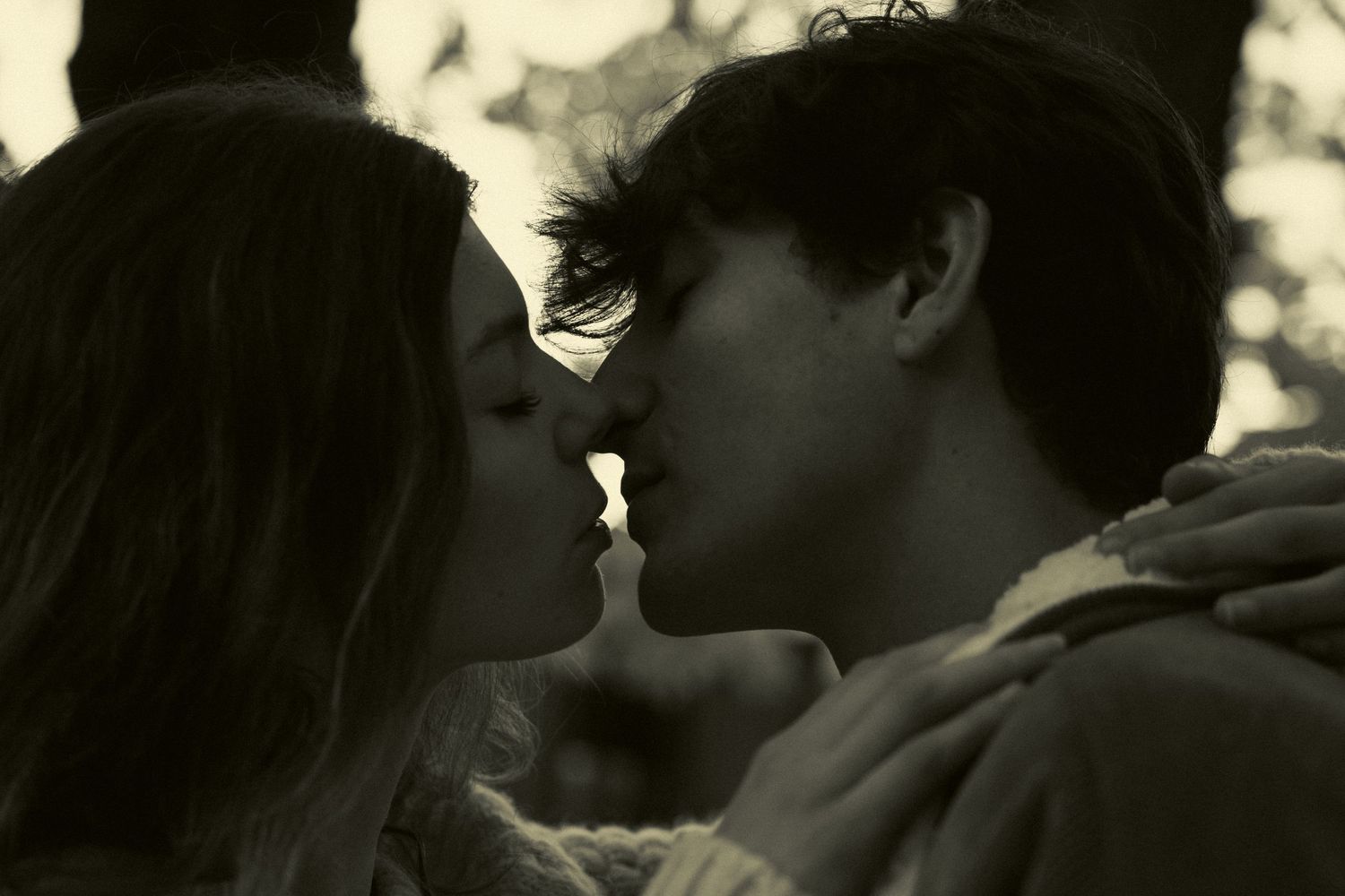 Intimate romantic moment captured in black and white tones.