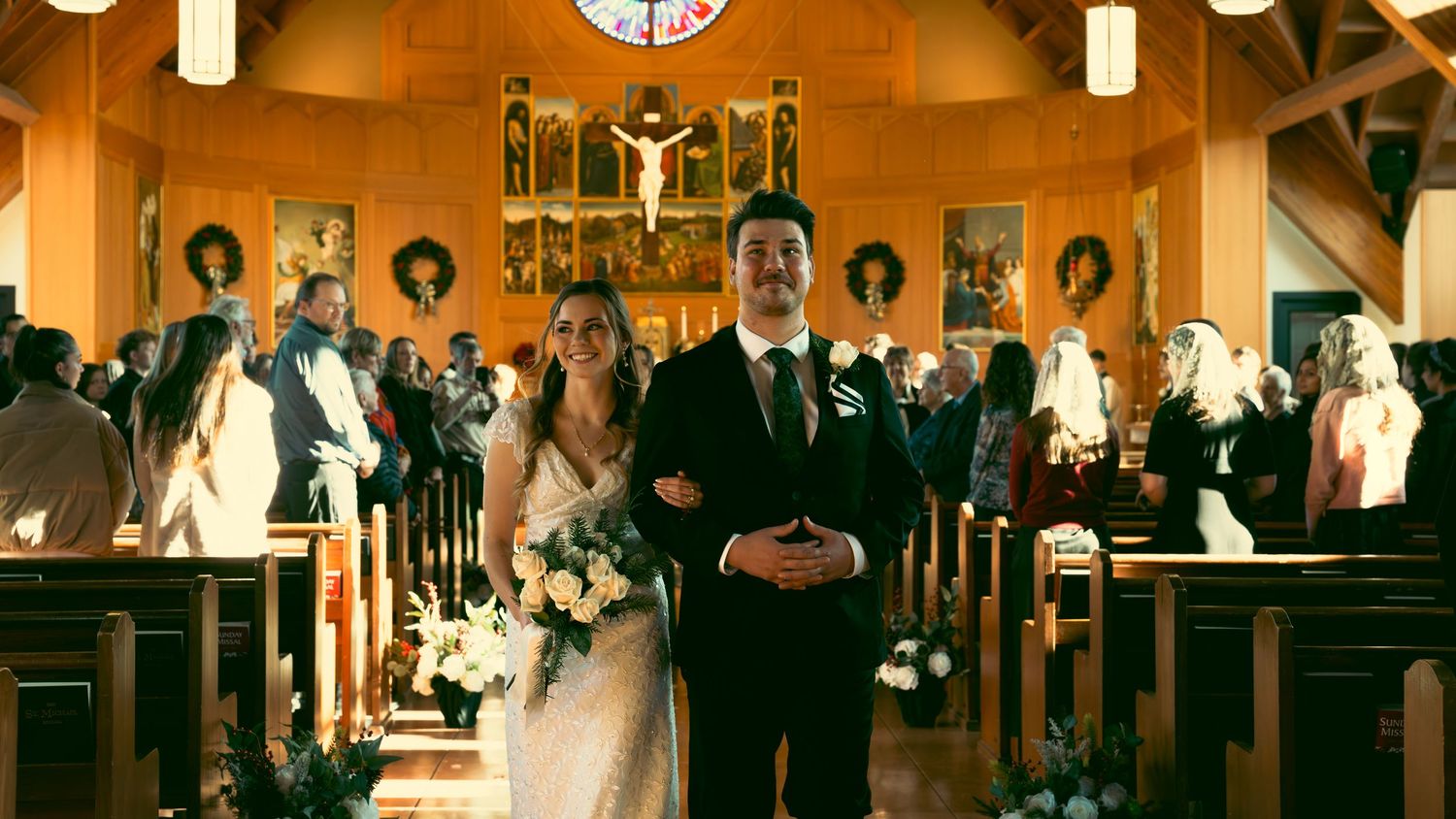 A traditional church wedding ceremony with guests seated in wooden pews under warm lighting.
