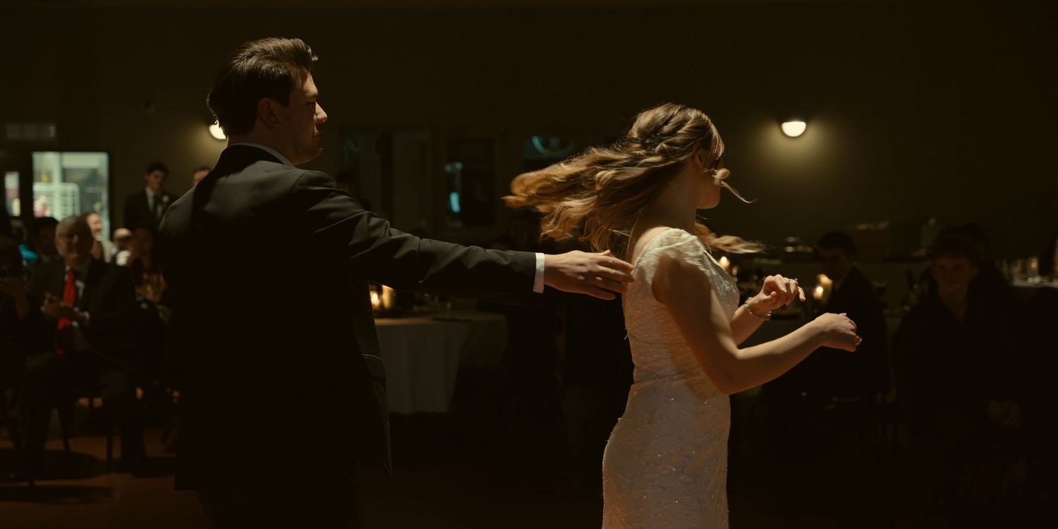 A couple dances in an intimate setting during their wedding reception.