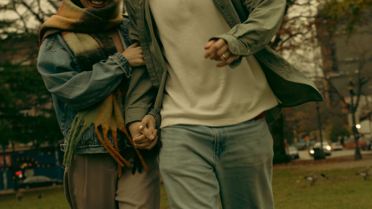 People walking together through an autumn park scene with a vintage sepia tone effect.
