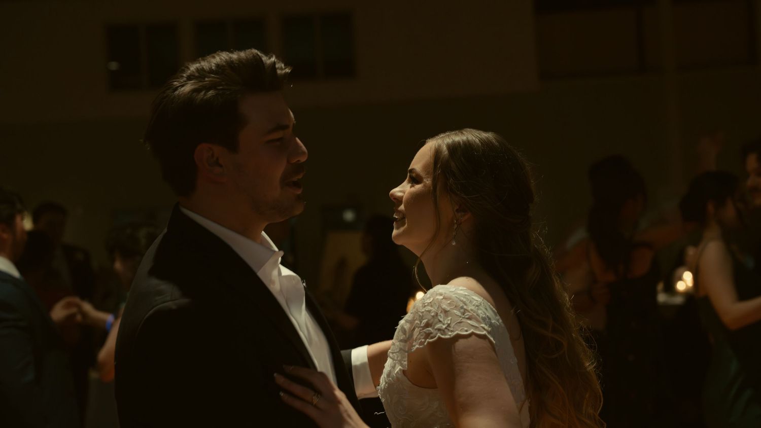Dark atmospheric reception photos capturing candid moments at an evening wedding celebration.