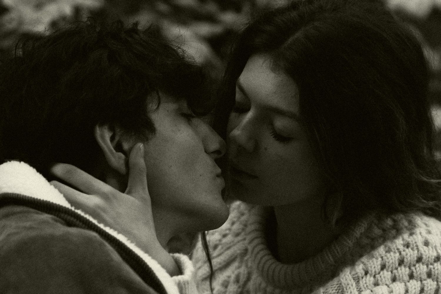 Romantic black and white portrait of a couple sharing an intimate moment.