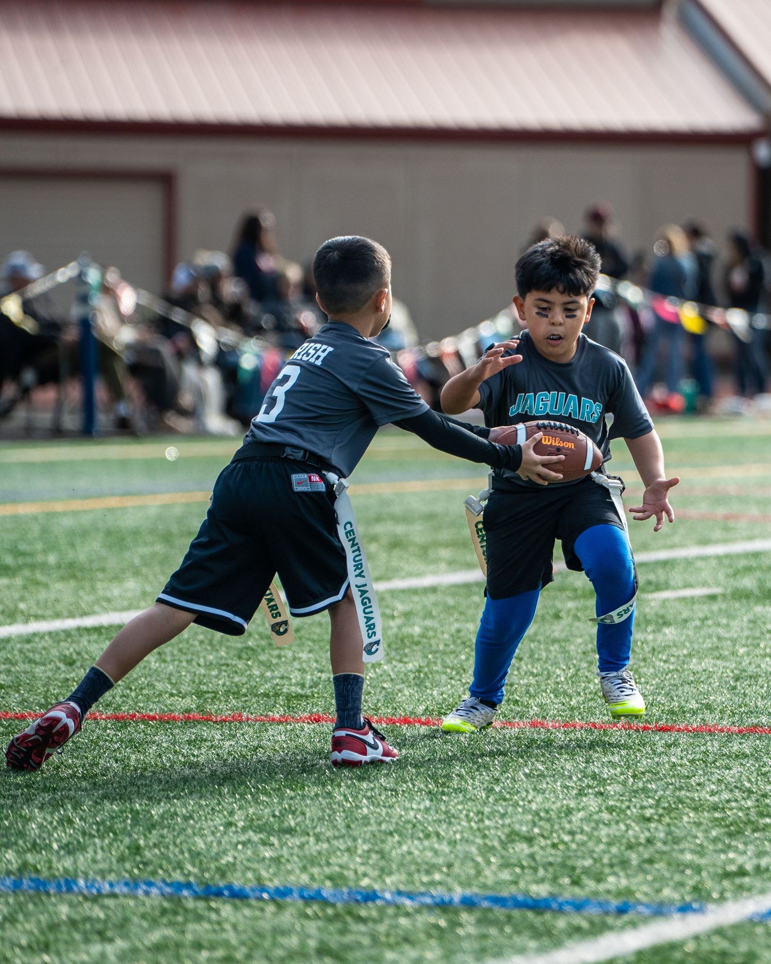 Young athletes practice diving drills on a turf field during sports training.