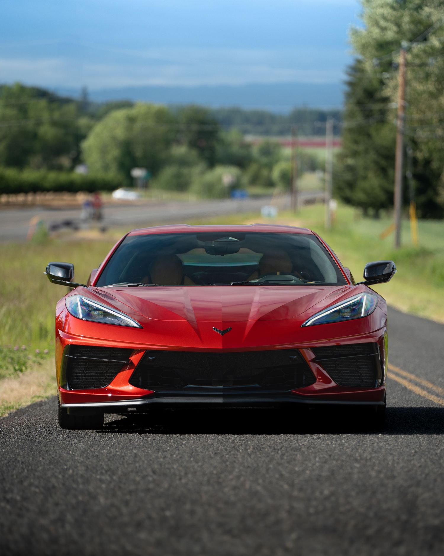 Front view of a red Genesis sports car showcasing its sleek aerodynamic profile.