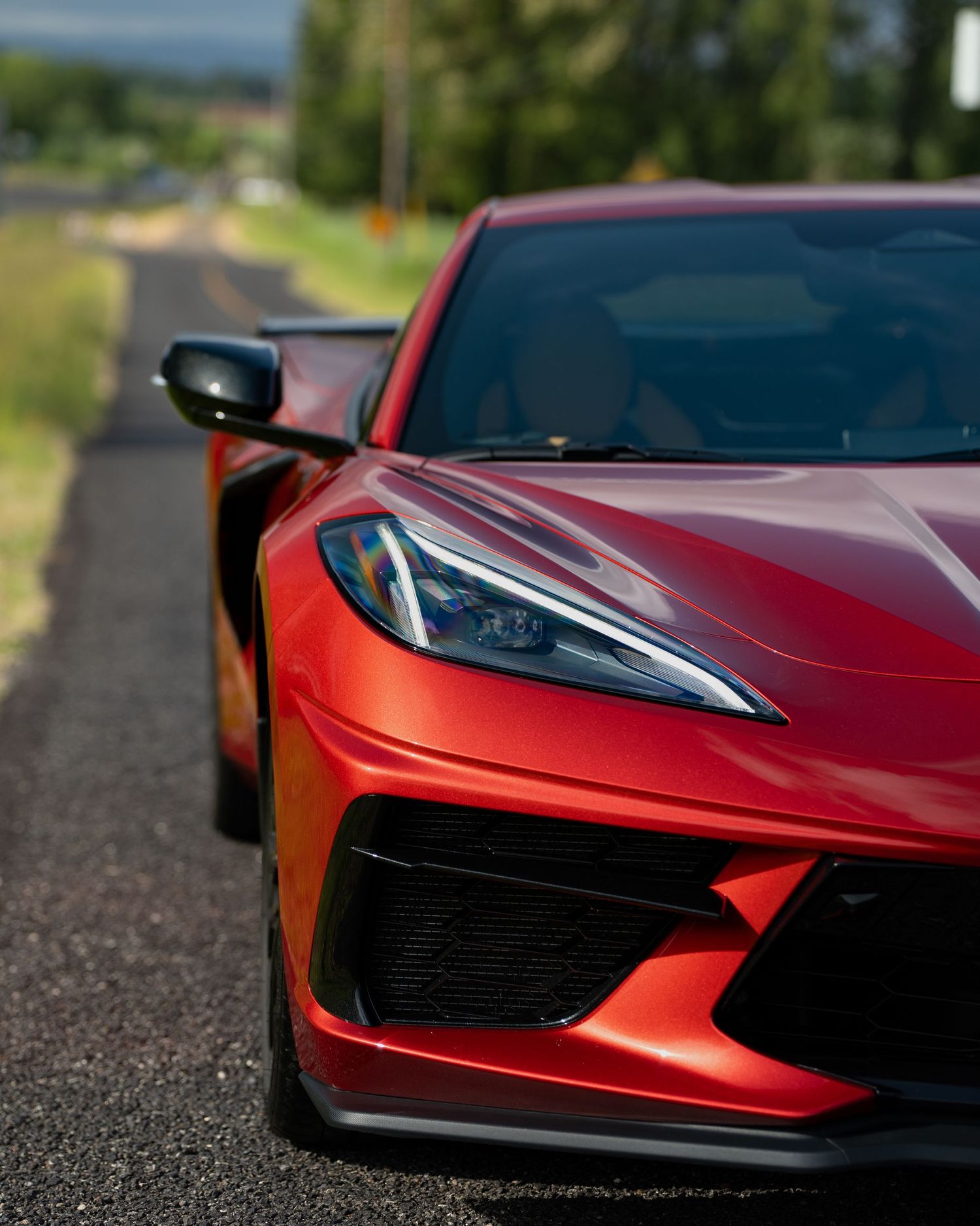 Close-up of the sleek red hood and front end design of a modern sports car.