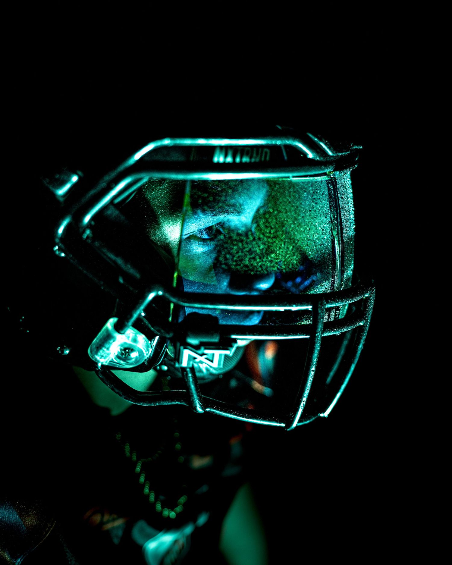 Glowing teal neon lights illuminate a dark room with multiple reflective surfaces creating a futuristic ambiance.