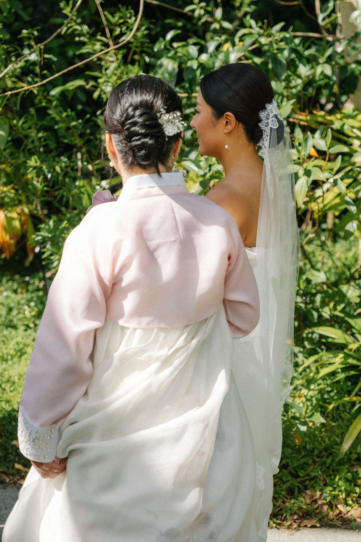 Three sequential photos show a couple in traditional wedding attire walking together in a garden setting.