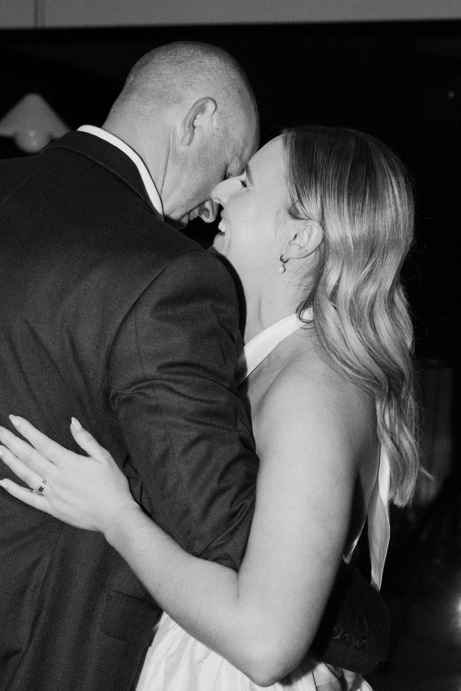 A romantic black and white photo sequence shows a couple dancing closely together at an event.