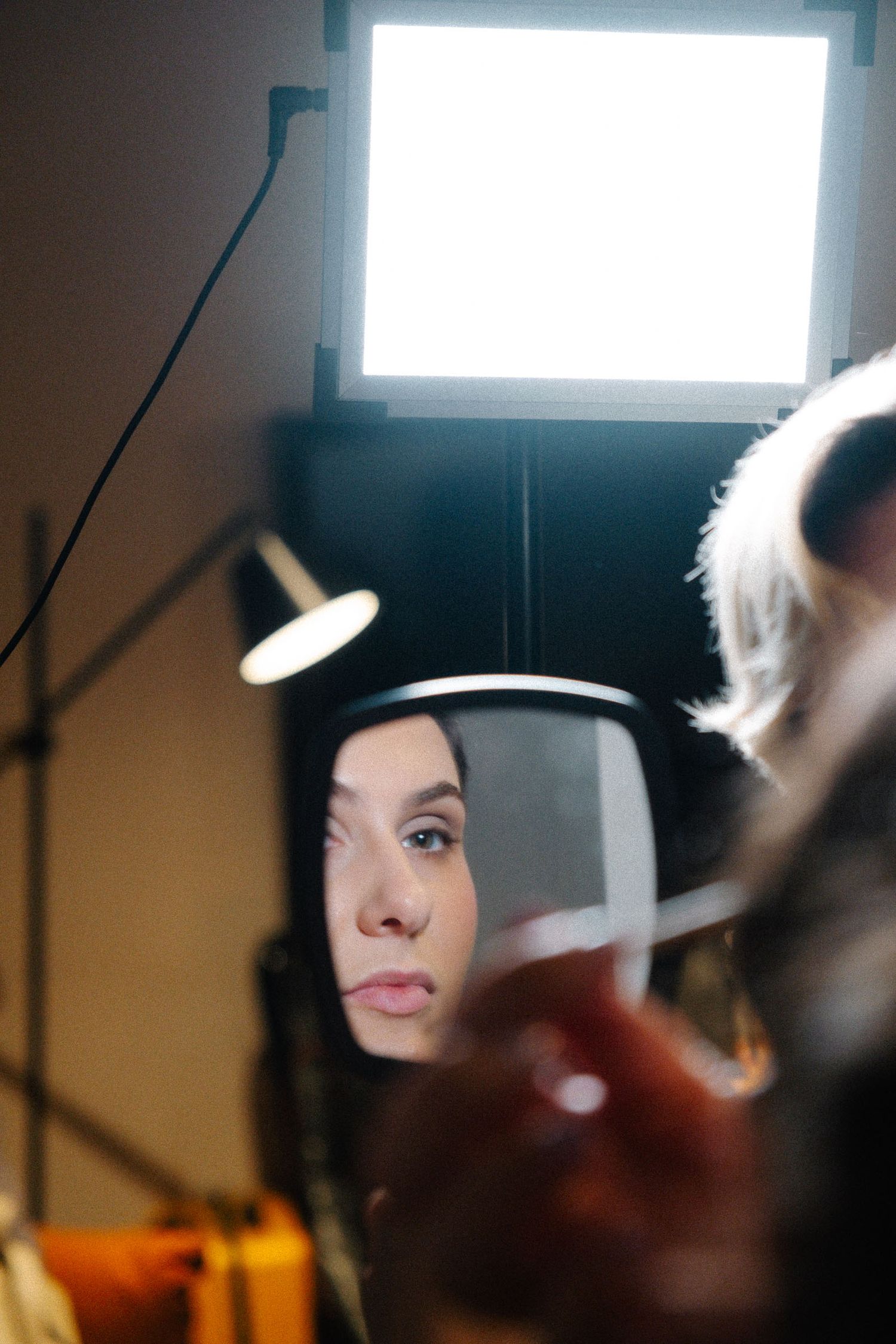 A sequence of close-up shots showing someone with dark hair illuminated by natural window light.