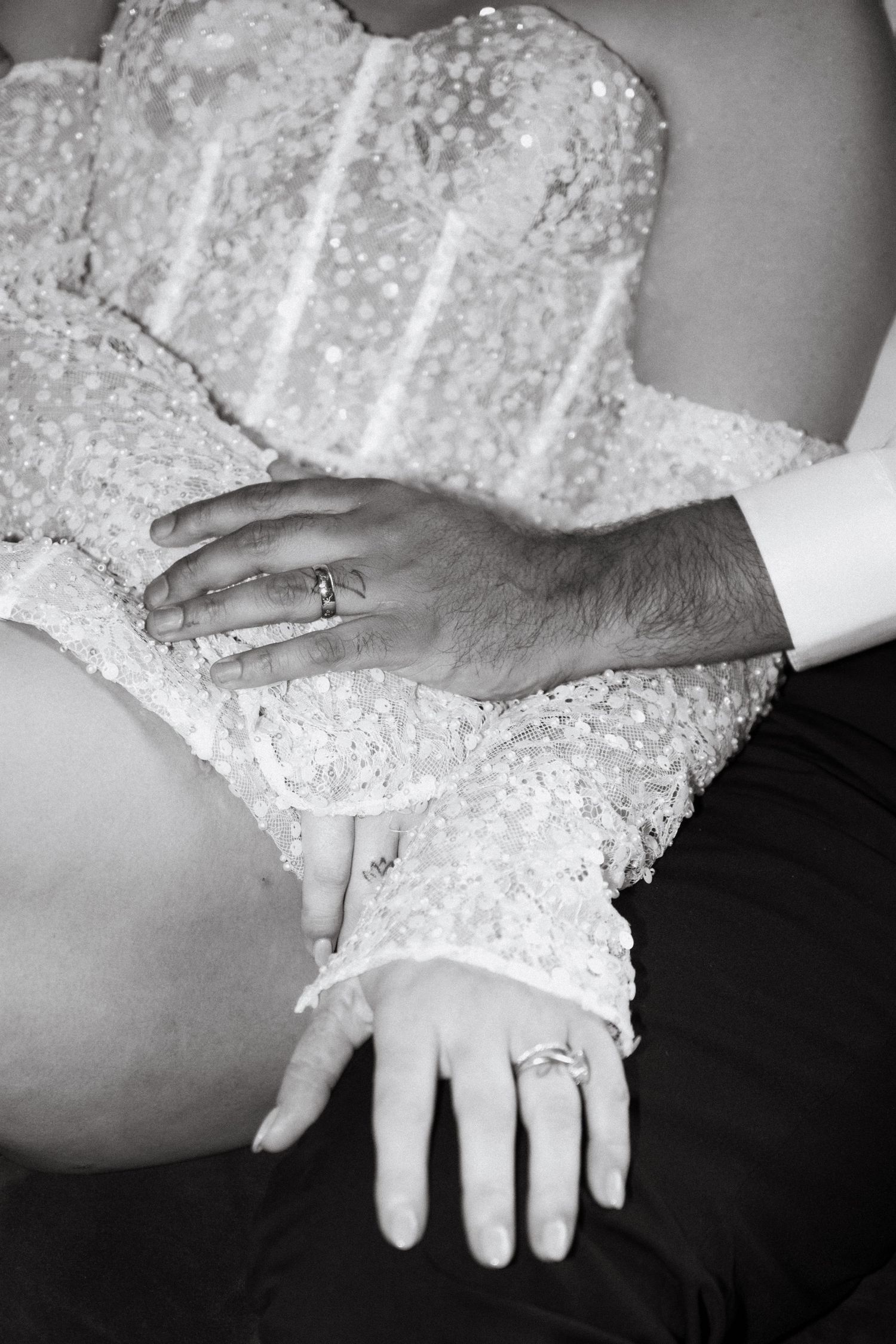 A series of black and white photos showing hands with wedding rings in a progressive sequence.
