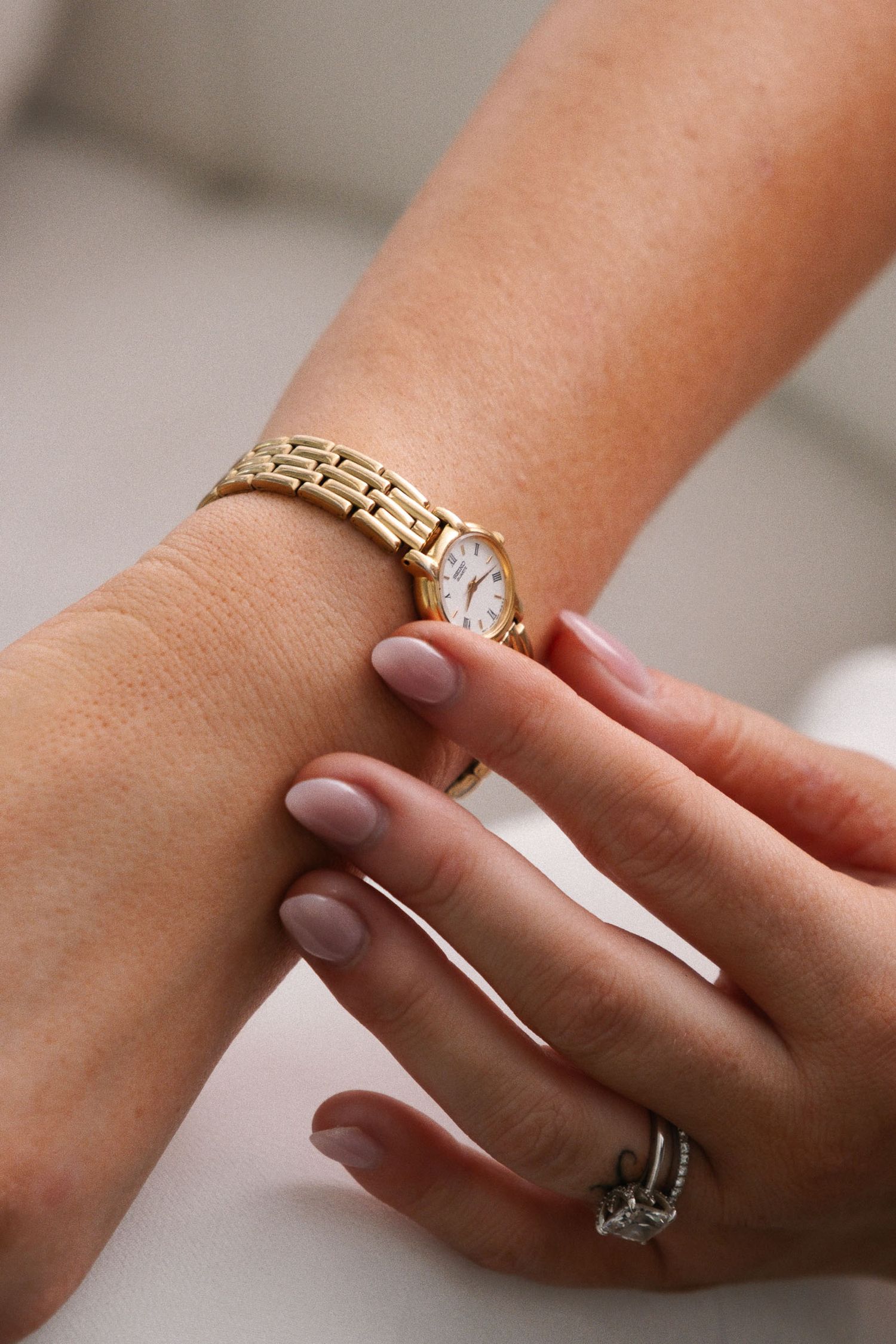 Close-up sequence of an elegant engagement ring with a sparkling diamond center stone set in gold.
