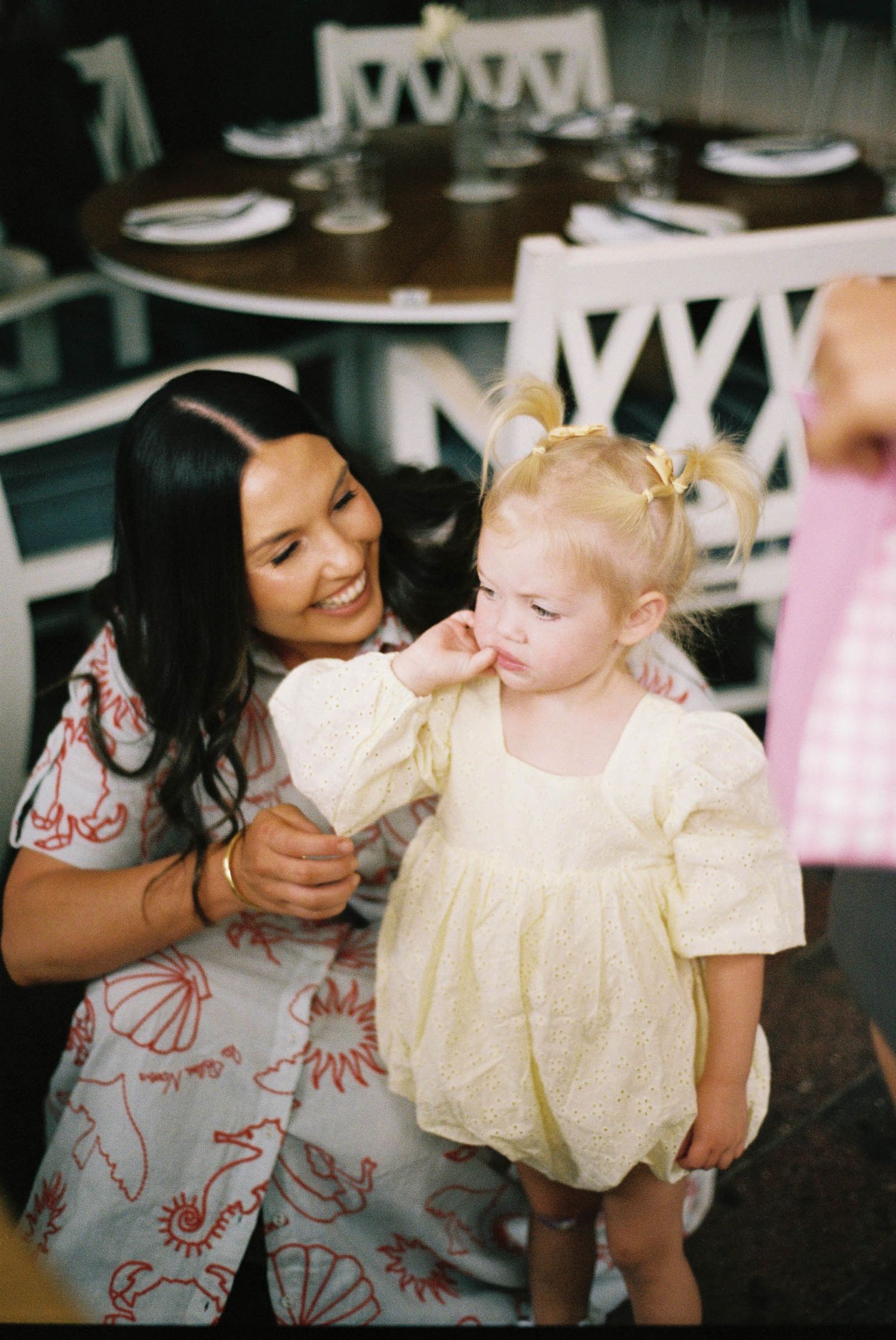 A series of candid photos showing joyful interaction between a caregiver and young child in a light-filled room.